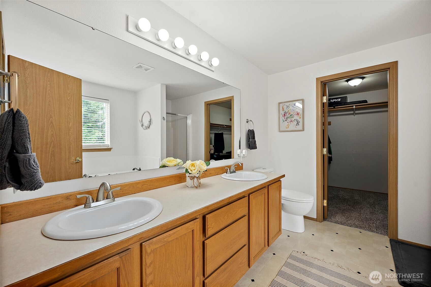 Ensuite bath with walk-in shower and soaking tub. You'll also find the huge primary walk-in closet at the othe end of the bathroom.