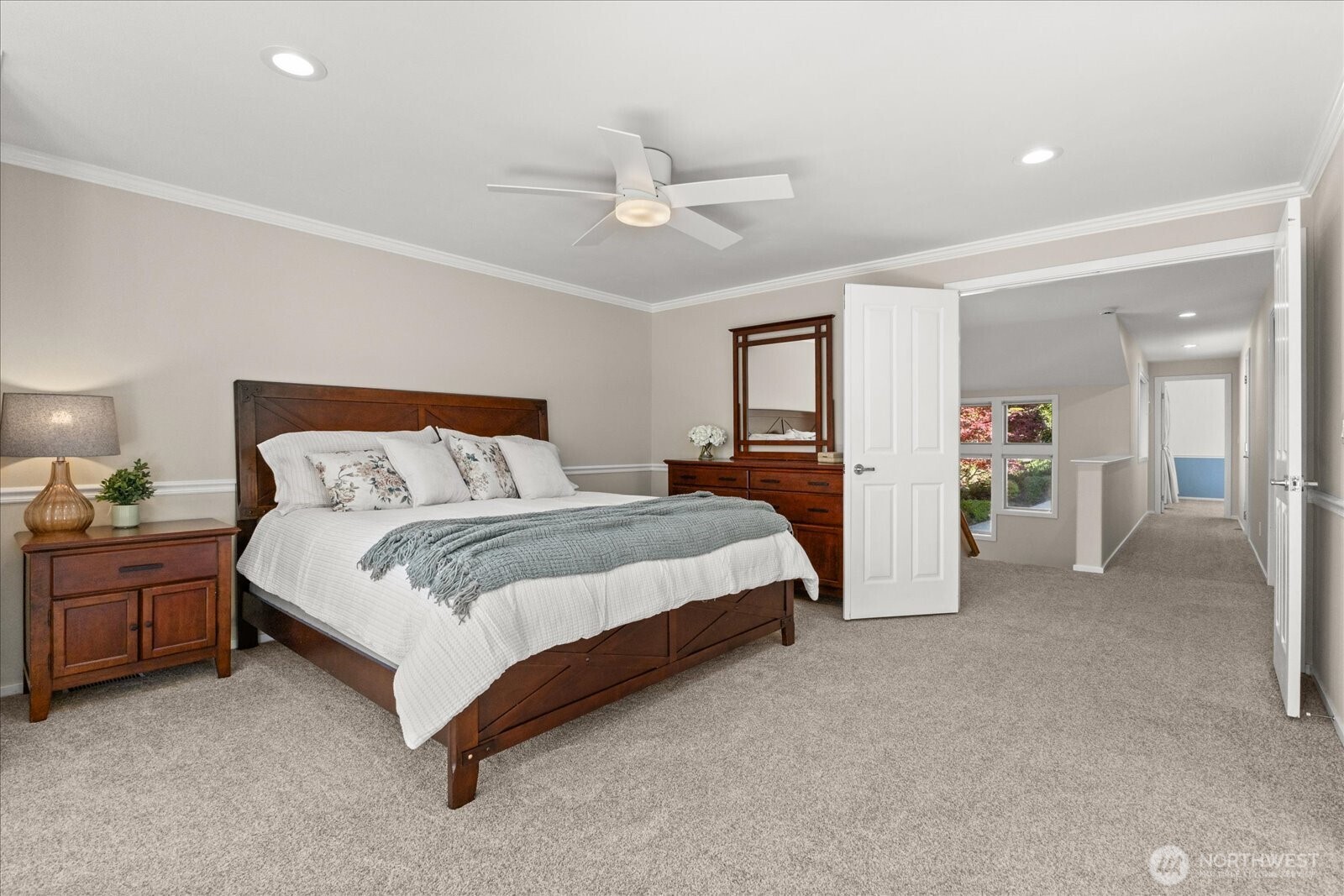 Light-filled primary suite surrounded by peaceful views