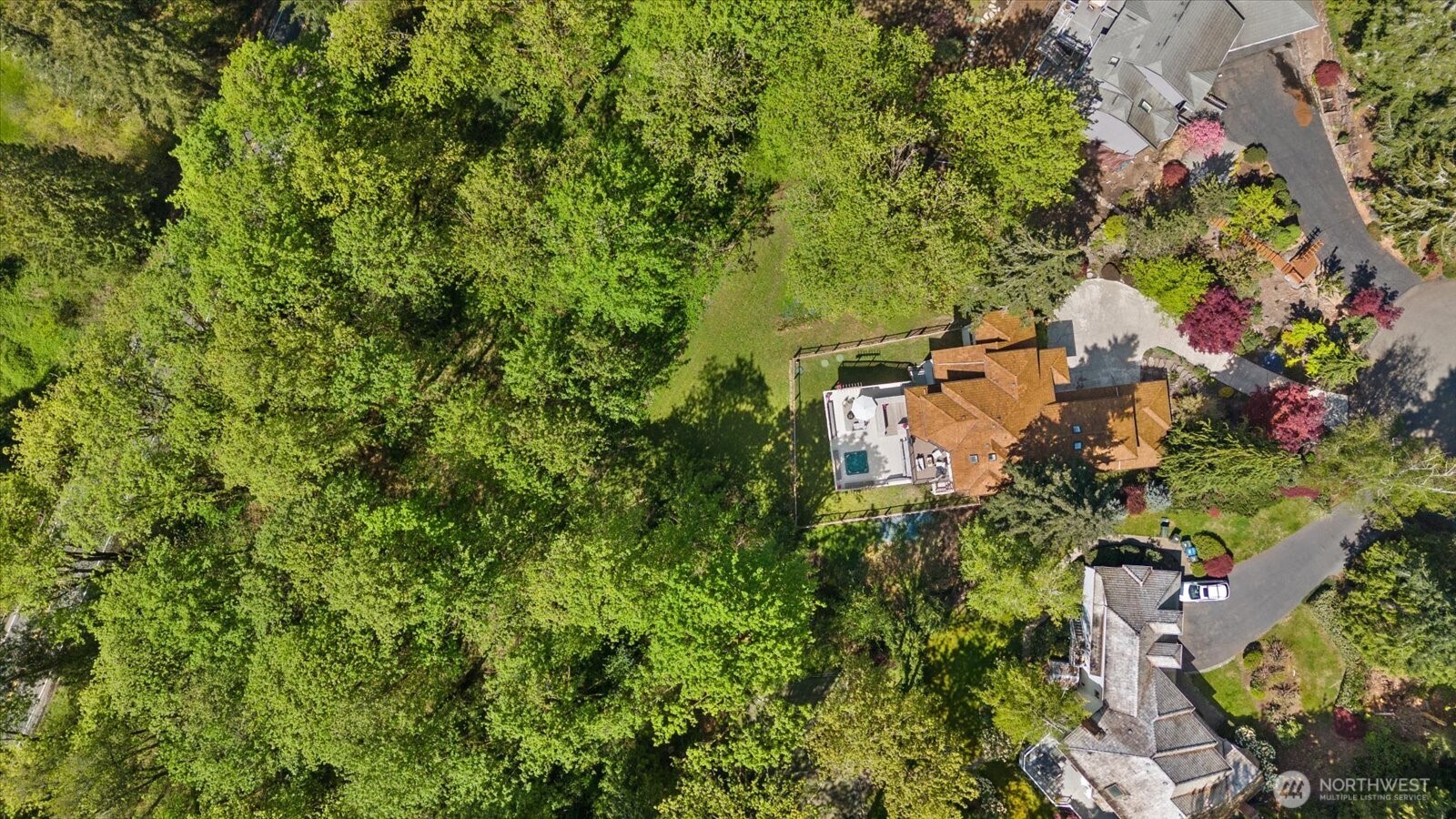 A breathtaking aerial perspective of this private wooded retreat