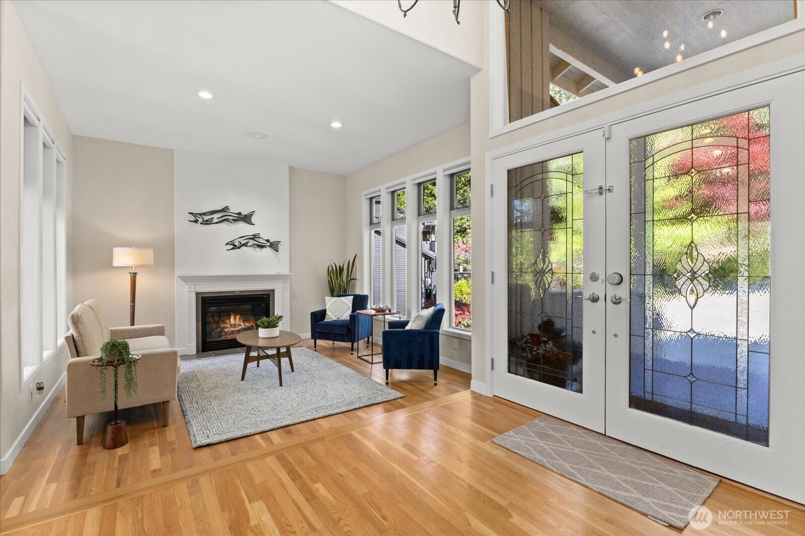 Warm hardwoods and soaring ceilings create a grand first impression