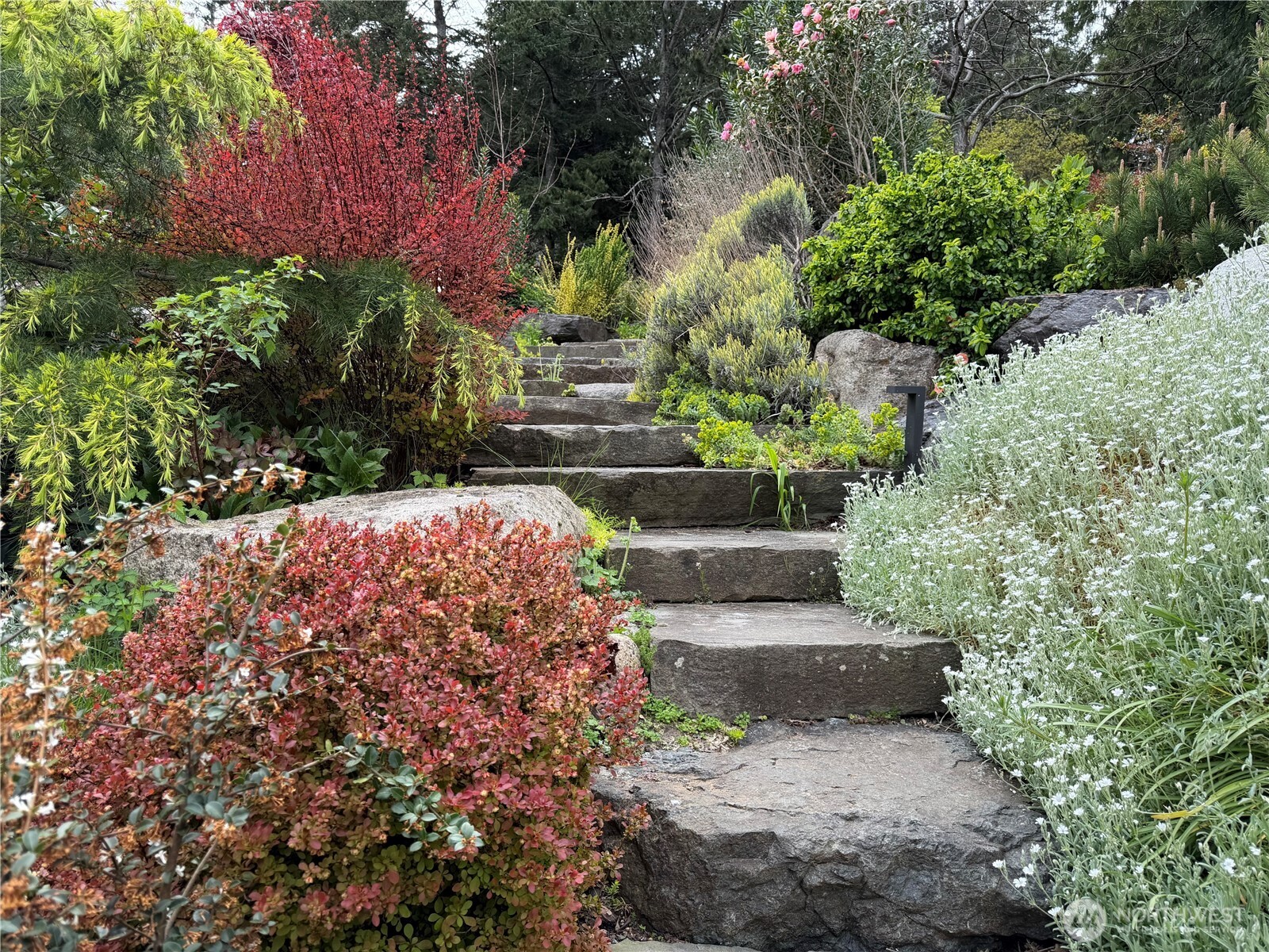 Stone pathway leading to garage and entrance. gate