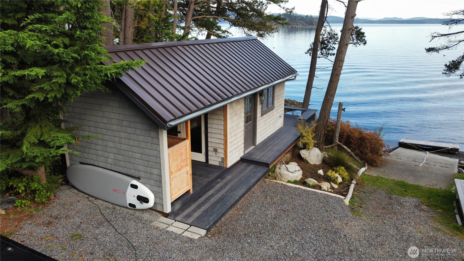 Boat house features a private studio for yoga, gym, office and loft bed or storage. Deck overhangs beach, composting toilet and outdoor shower ready for installation. Dry and heated.