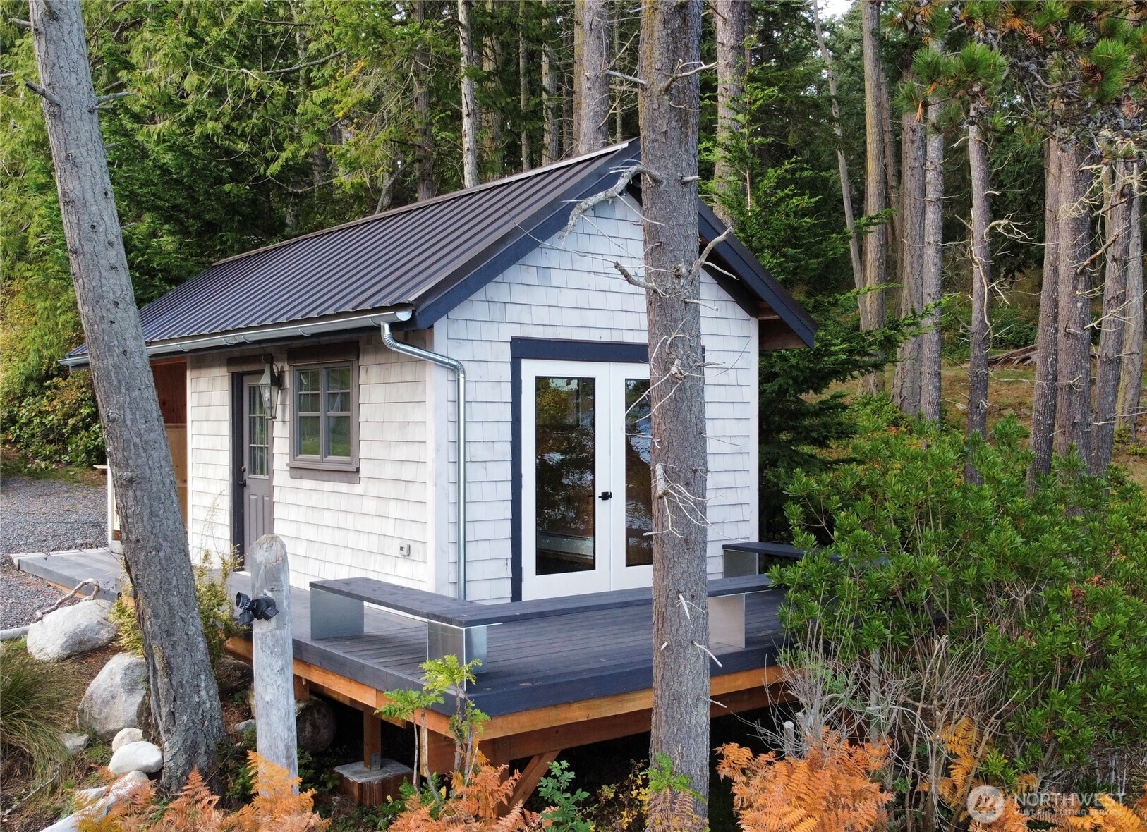 Perched just above the beach, the boathouse deck features French doors that open to the shoreline, creating an intimate, one-of-a-kind space to take in the sights and sounds of the water.