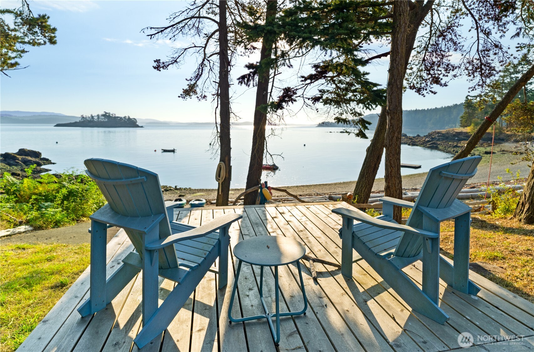 Near the boathouse, a dedicated viewing patio offers a peaceful vantage point, one of many intimate spaces designed for soaking in the sun and natural beauty of the property.