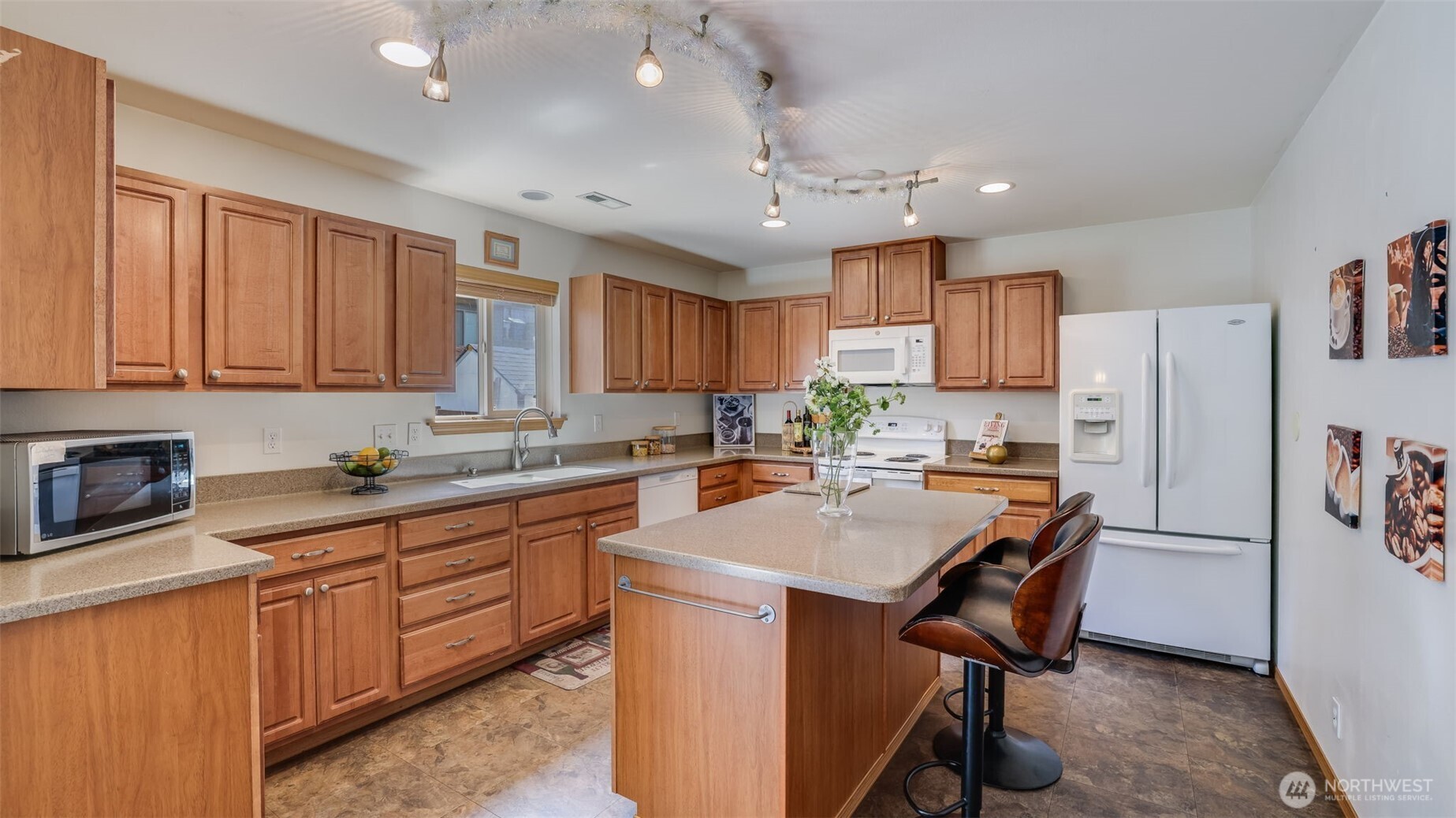 Warm wood cabinets bring natural charm and style to this inviting kitchen, offering elegance