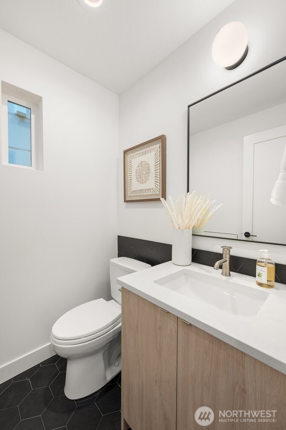 Modern powder room featuring a floating vanity and minimalist designer fixtures.