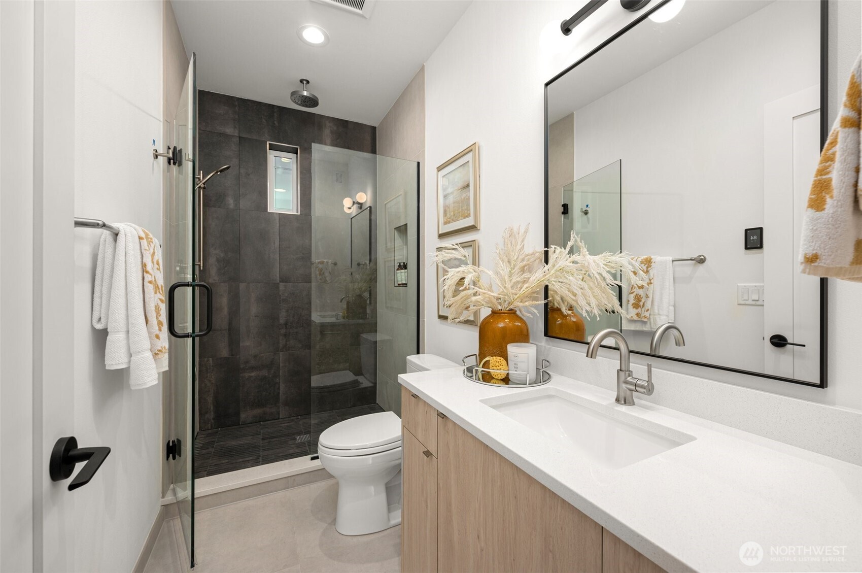 Spa-like primary bath with a double floating vanity and sleek, modern hardware.