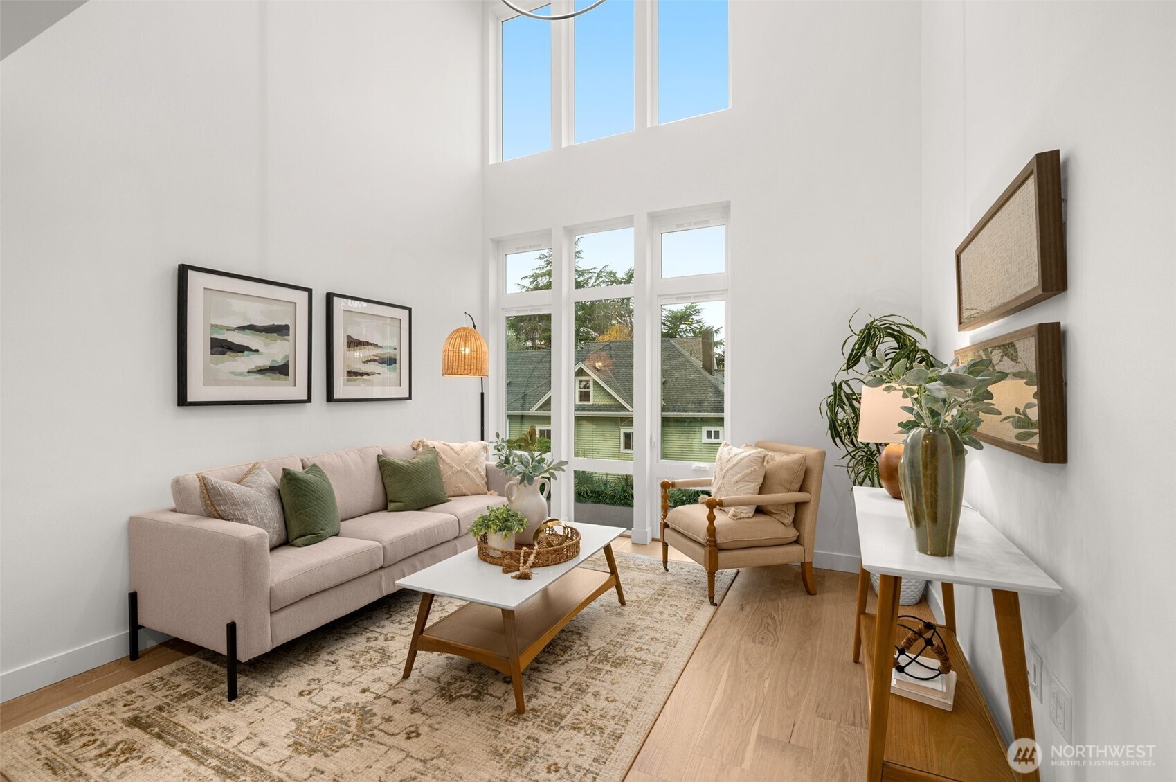 Dramatic open-concept living featuring soaring ceilings and oversized windows.