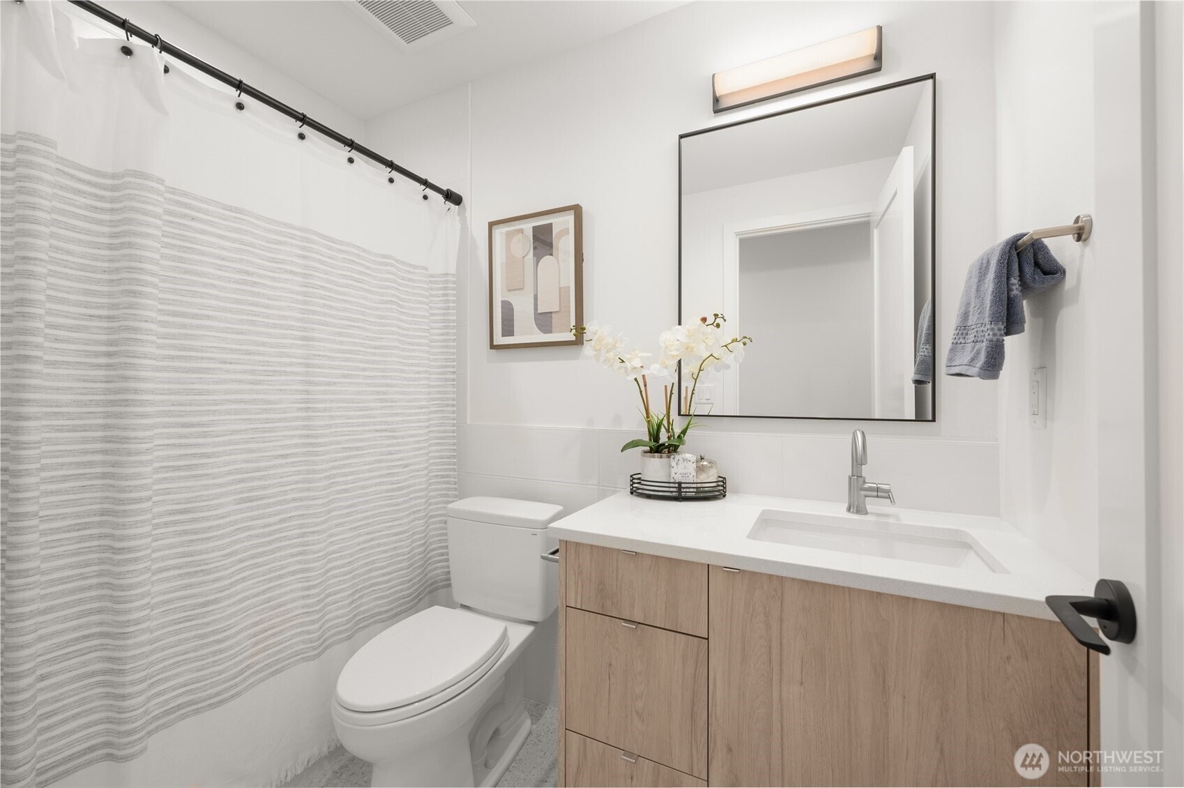 Full secondary bathroom with a contemporary vanity and designer lighting