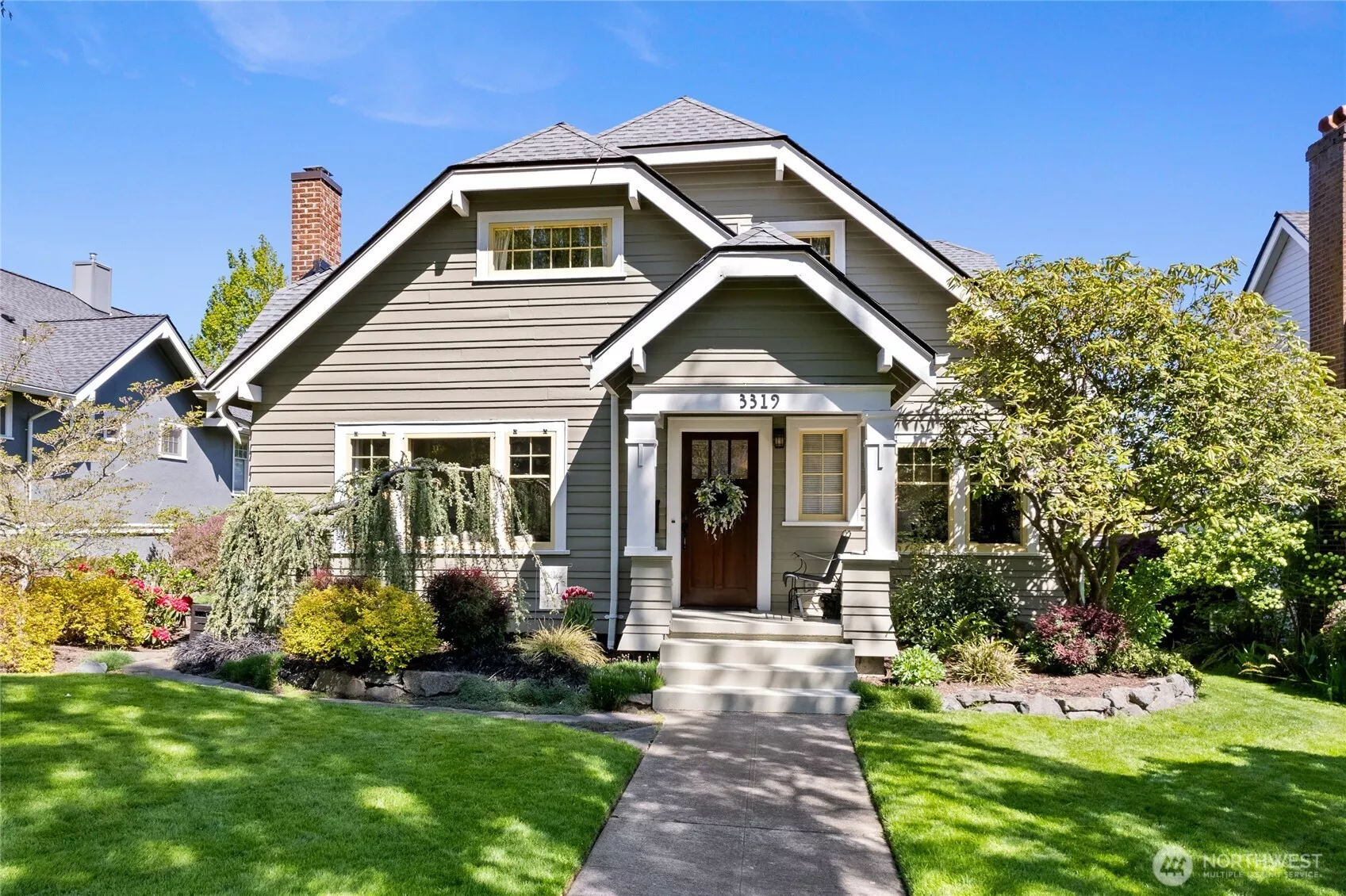 Well chosen landscaping adds to the street appeal of this North Tacoma Craftsman home.  New roof in 2021. Exterior painted in 2021.