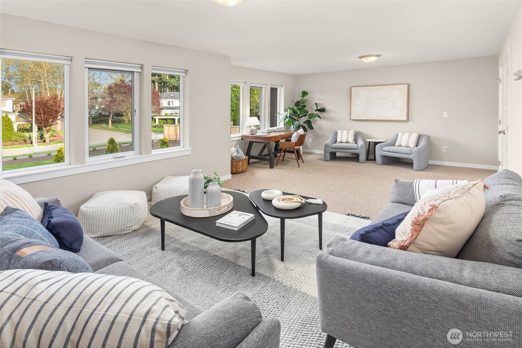 Expansive bonus room with a wall of windows.