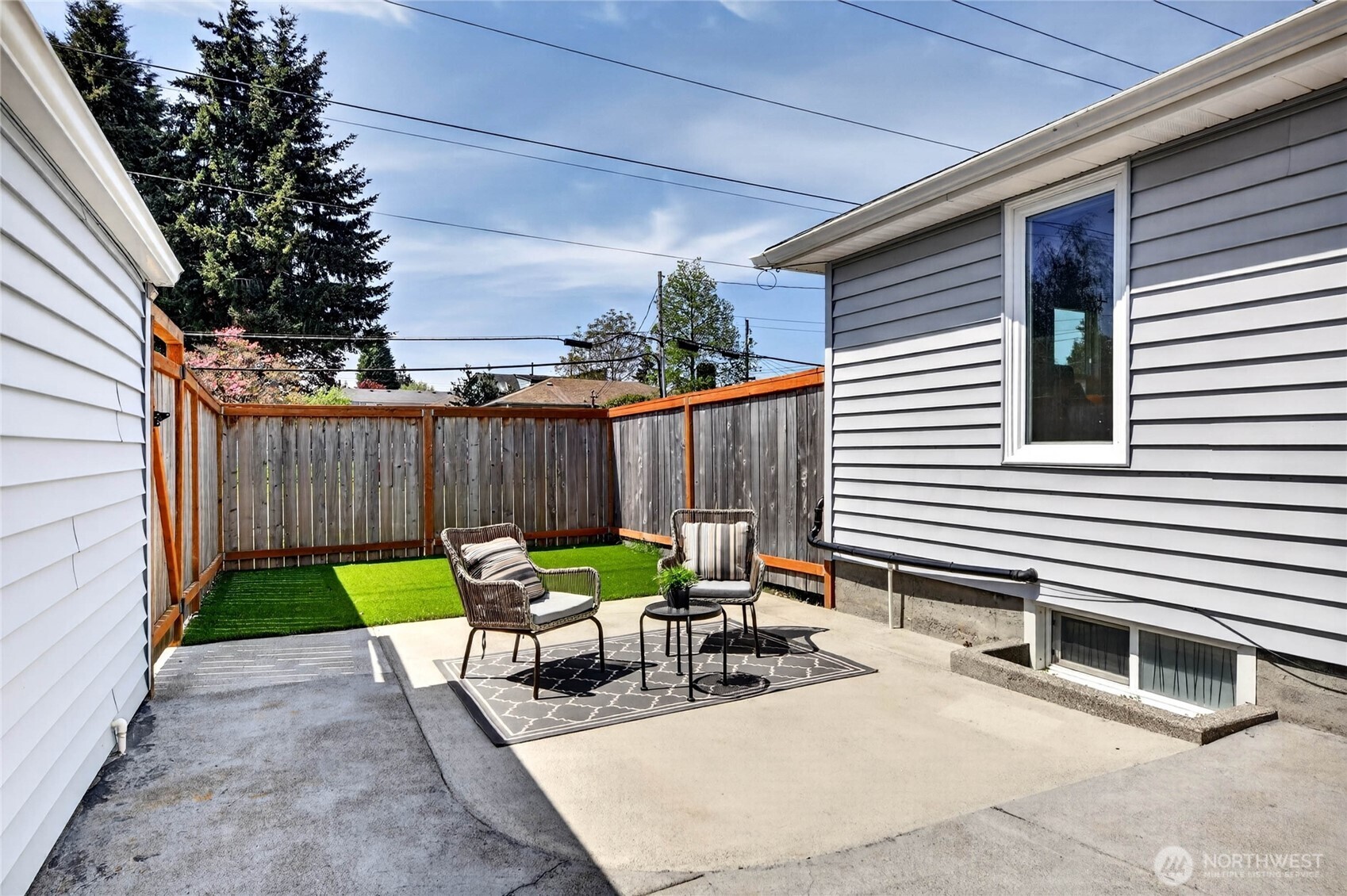 Fully fenced back yard with sitting area