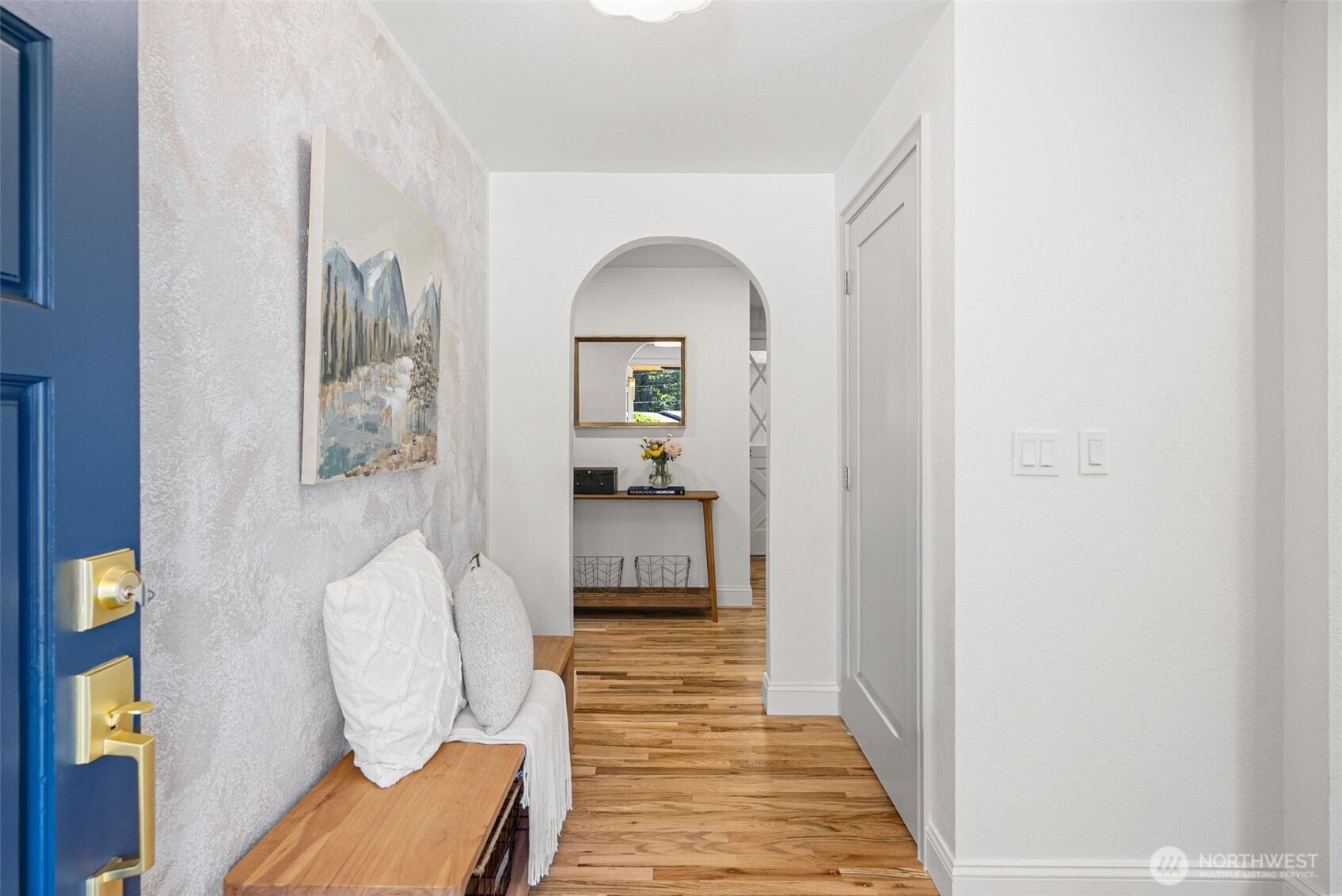 The entry way is highlighted by the arched doorway- complete with coat closet and space to greet your guests.
