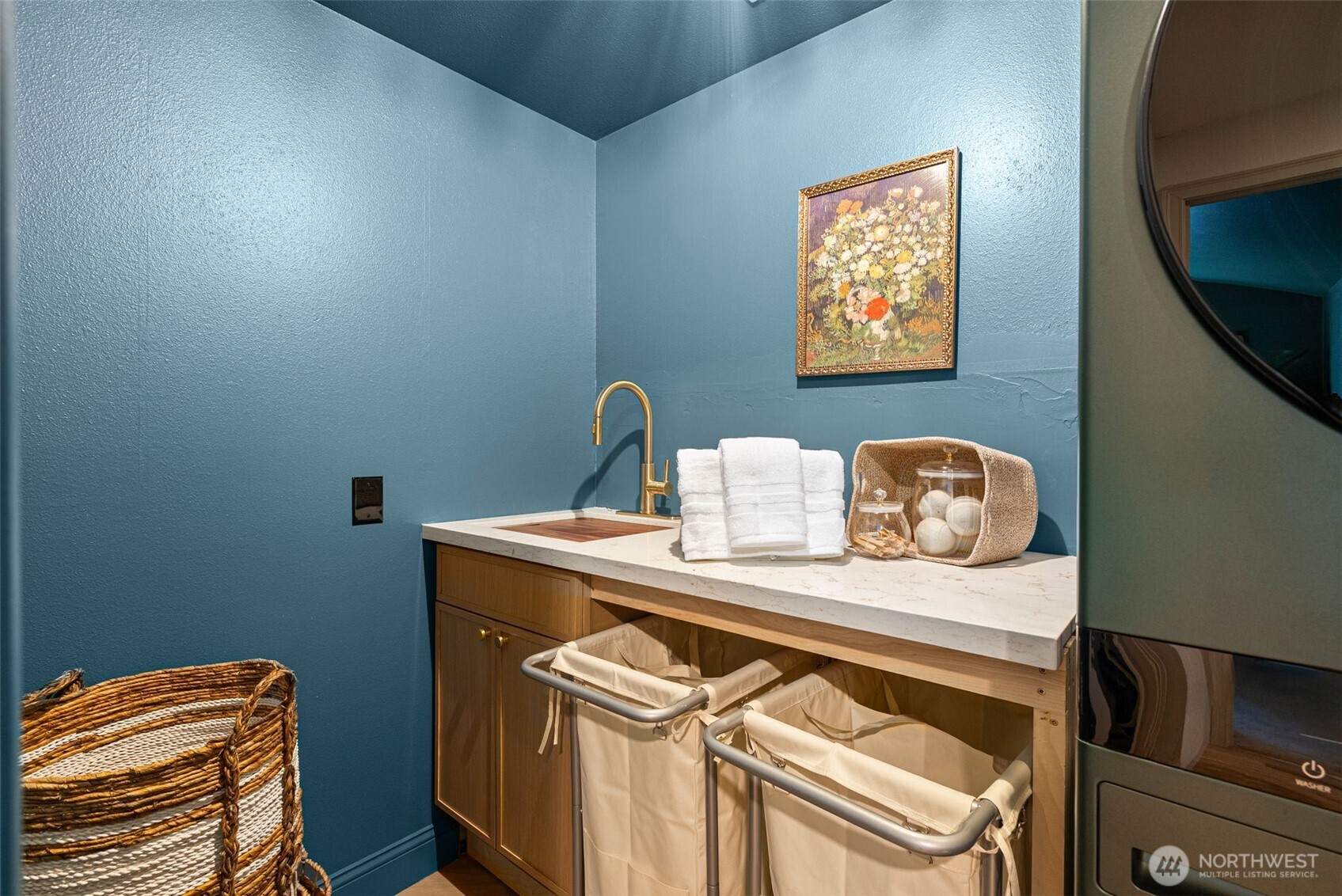 The laundry room is centrally located and updated to inspire.