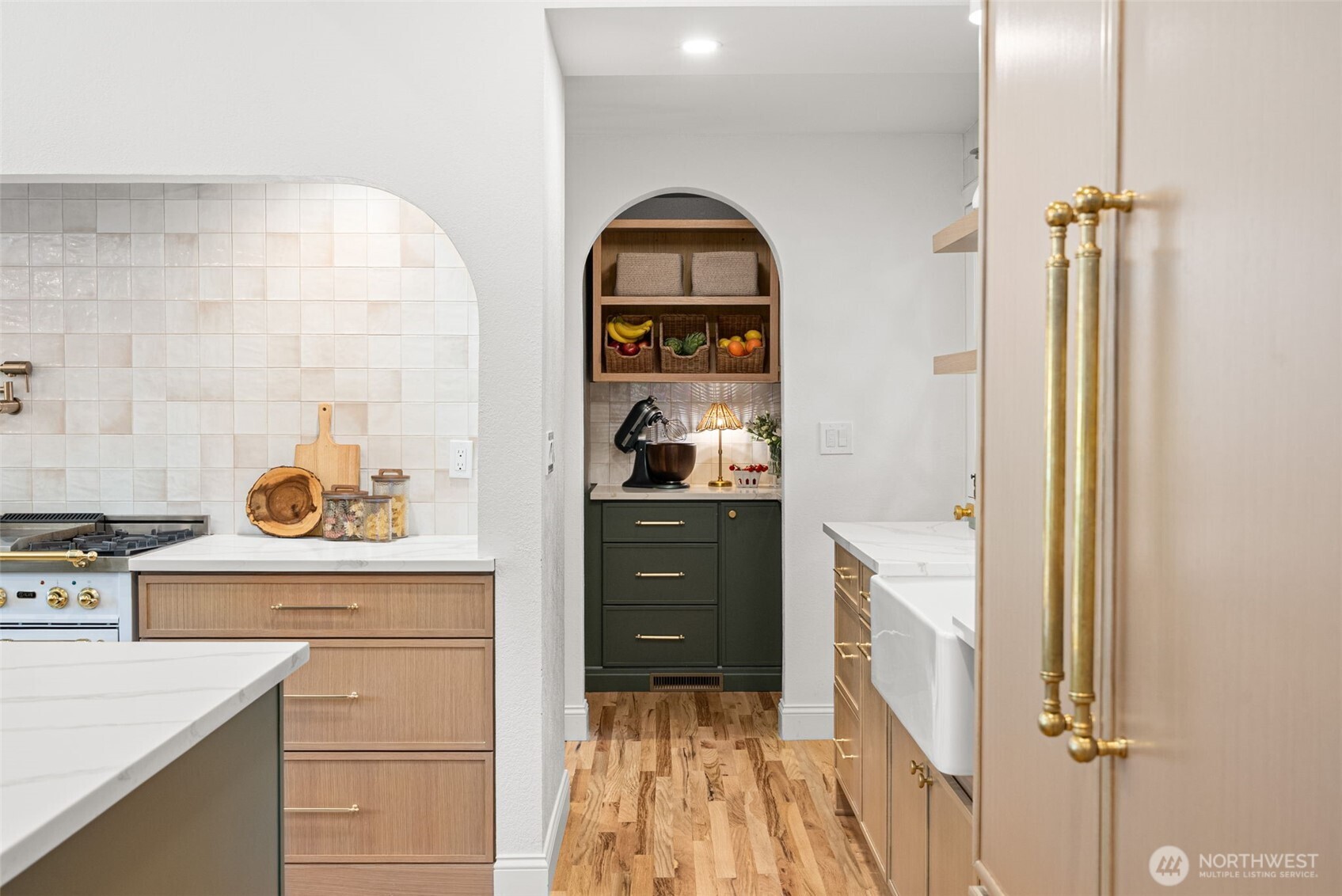 Pantry off the kitchen has plenty of storage and market shelves to tastefully store all your supplies.
