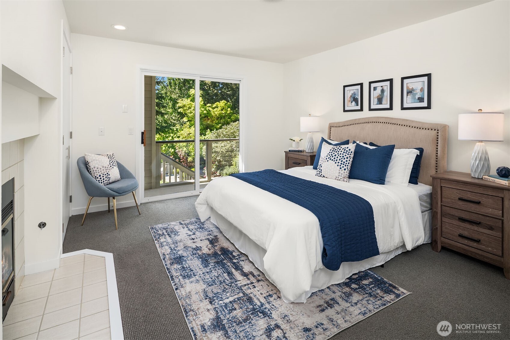 Guest bedroom with fireplace and slider to deck