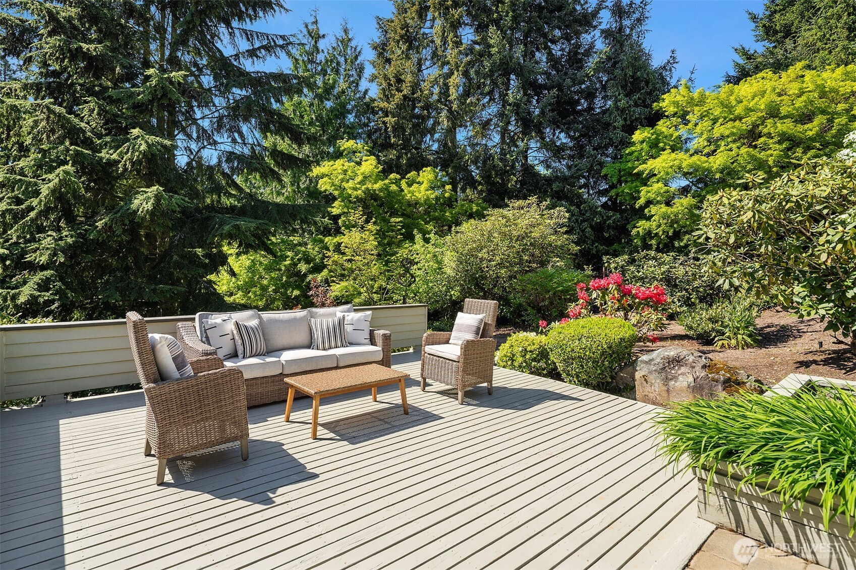 Spacious deck surrounded by beautiful landscaping