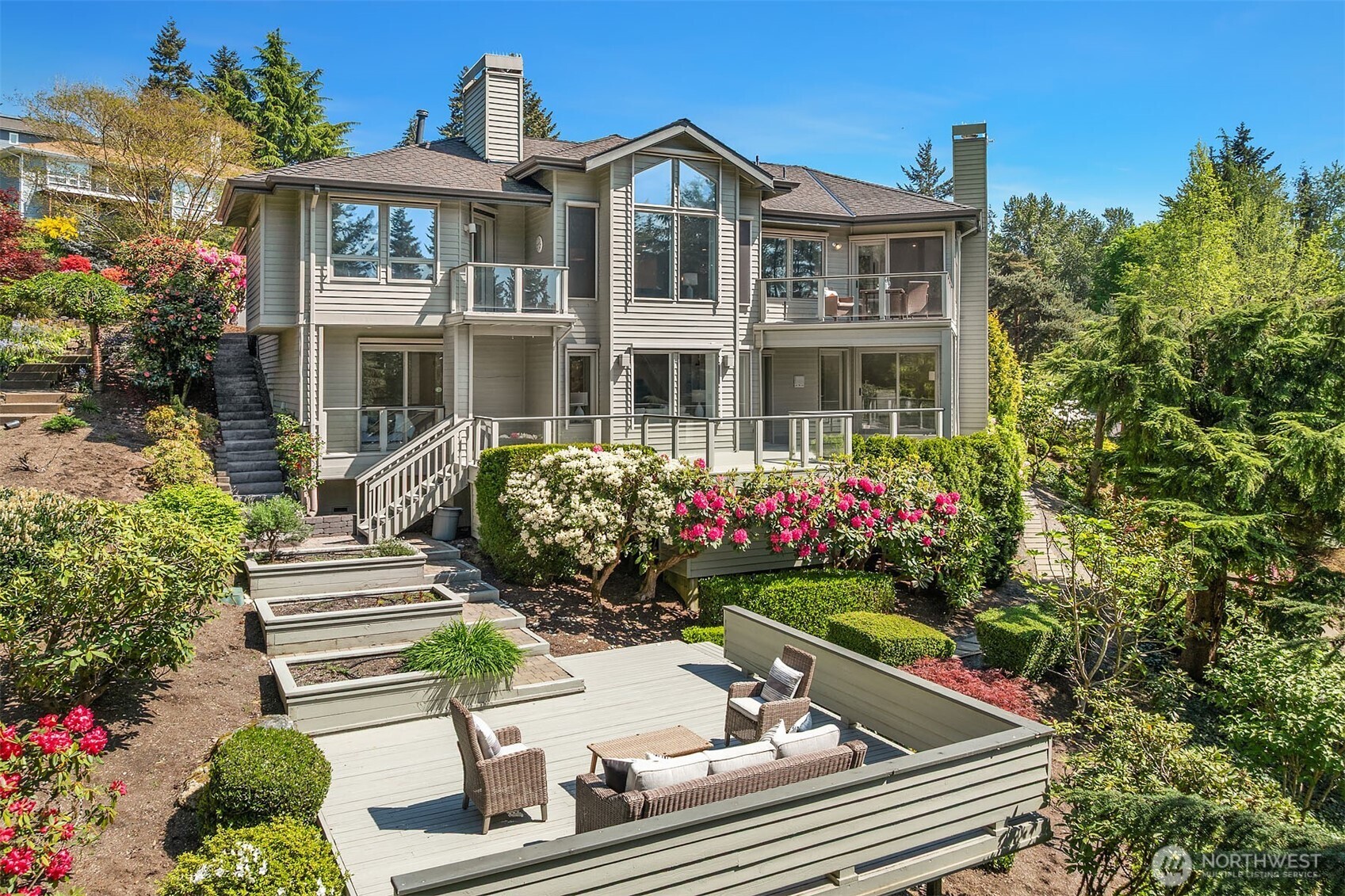 Enjoy sun-filled spaces, raised garden beds and large deck for relaxing