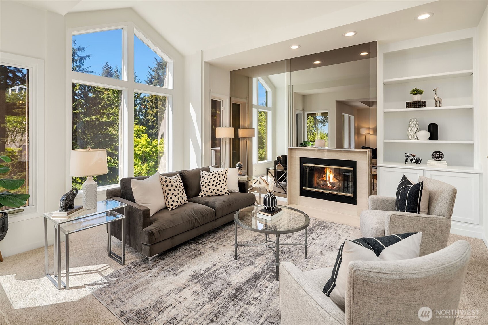 Living room offers cozy gas fireplace and beautiful views
