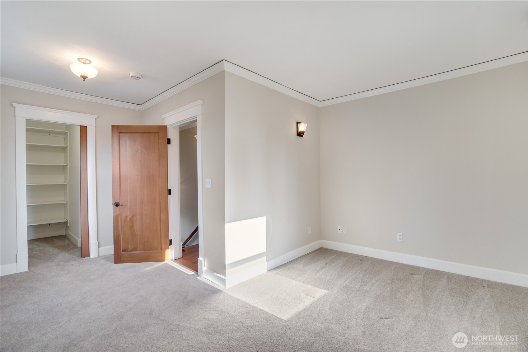 Generous rooms, walk-in closet, crown molding — and this is the secondary bedroom.