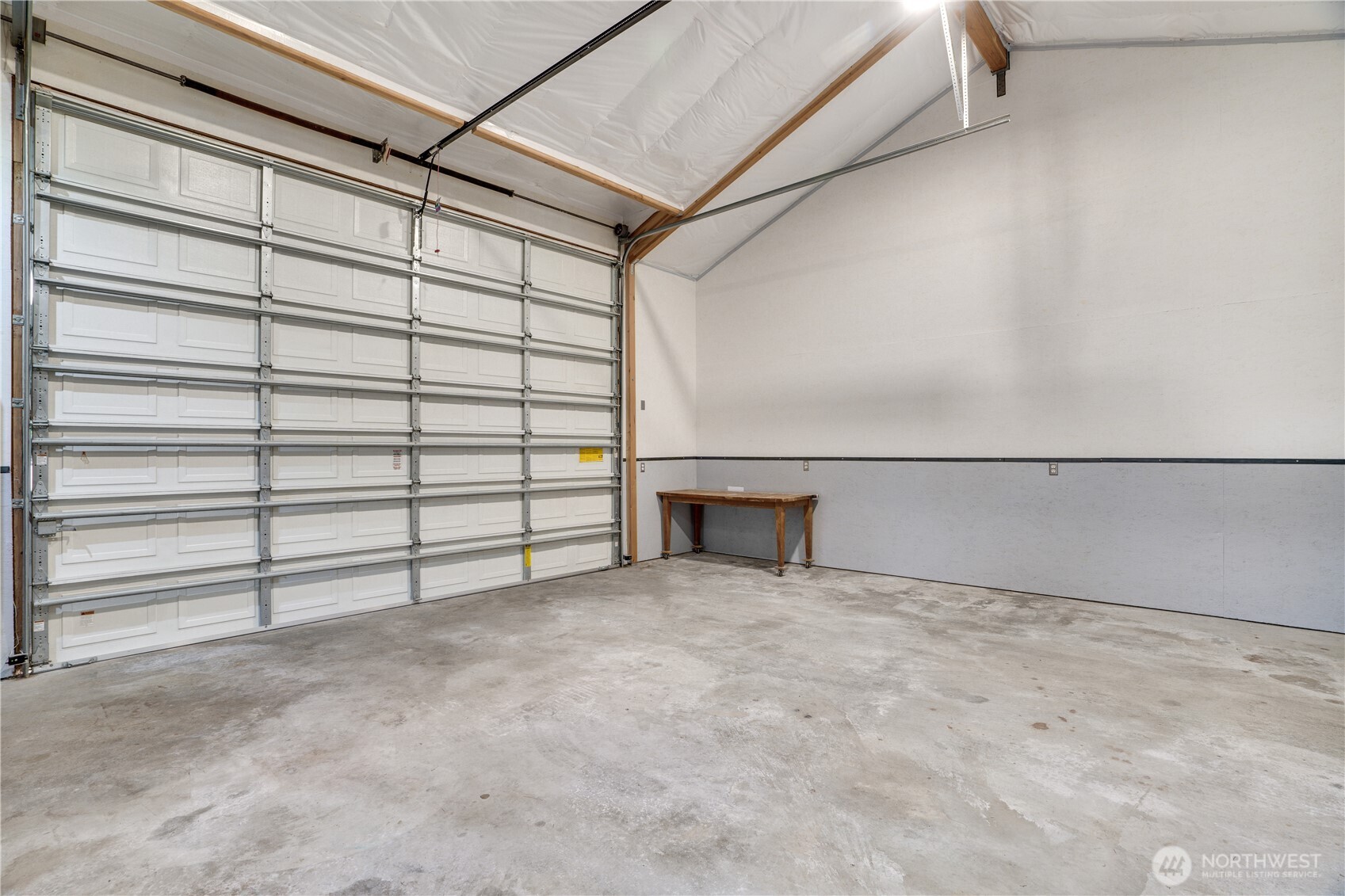 Full overhead clearance. 16” wide by 12” high garage door. Fully insulated. Wainscoted walls. Outlets where you need them. This bay means business.