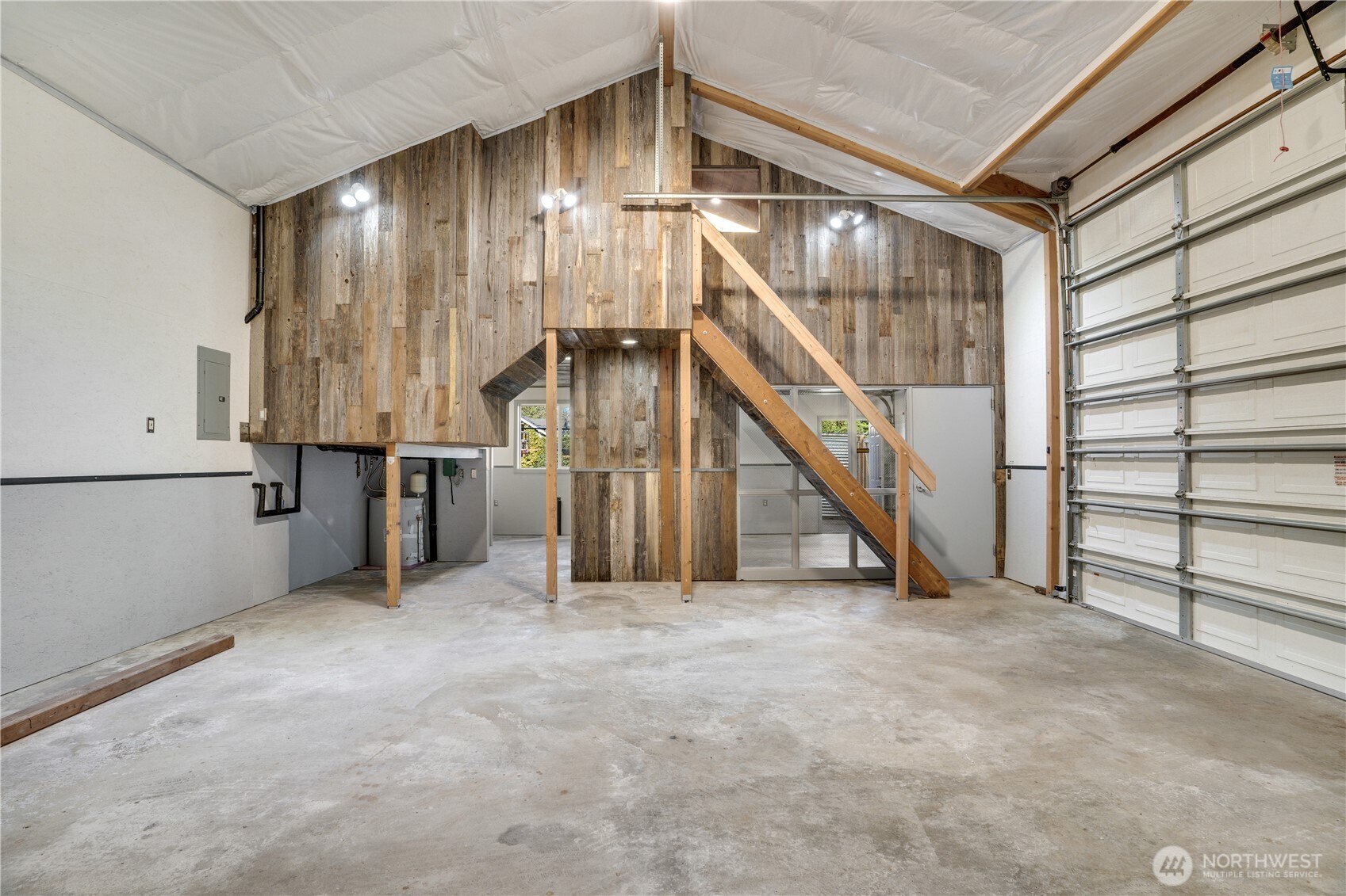 Floor to ridge. Reclaimed wood. Open loft. The panel is on the left. The staircase is straight ahead. Welcome to the shop.
