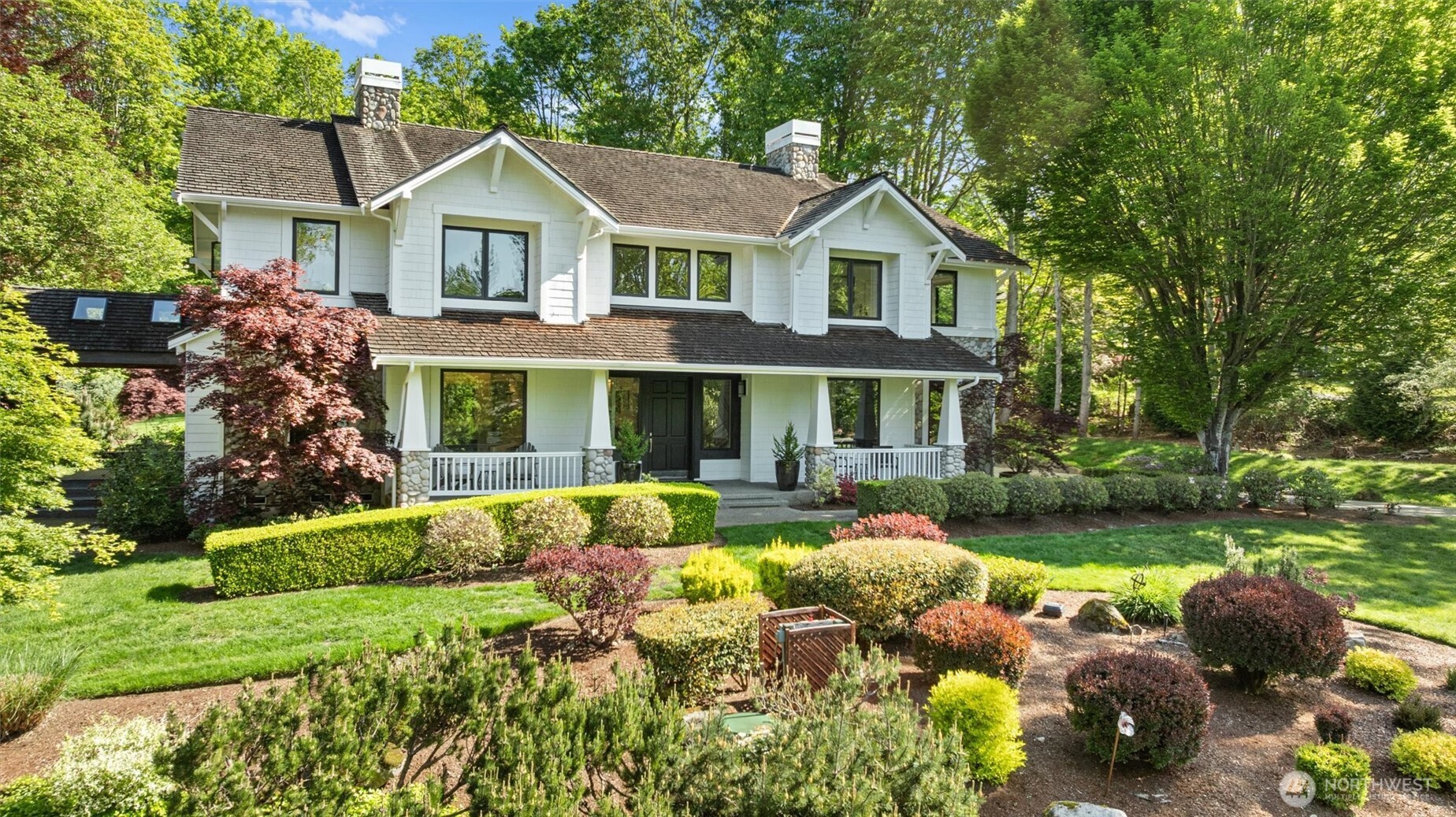 Oversized three-car garage has EV charger and storage room. Enjoy the idyllic winding driveway.