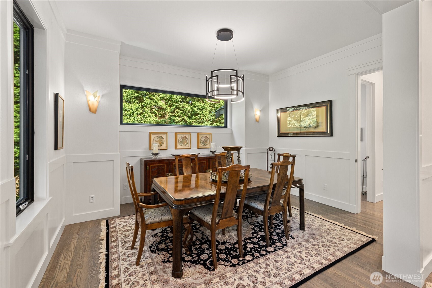 Stunning designer kitchen by Blue Plum- featuring induction cooktop, access to the covered side patio, and the entire wall along the left of this photo is exceptional pantry space! Also notice the extra storage cabinets along the seating area.