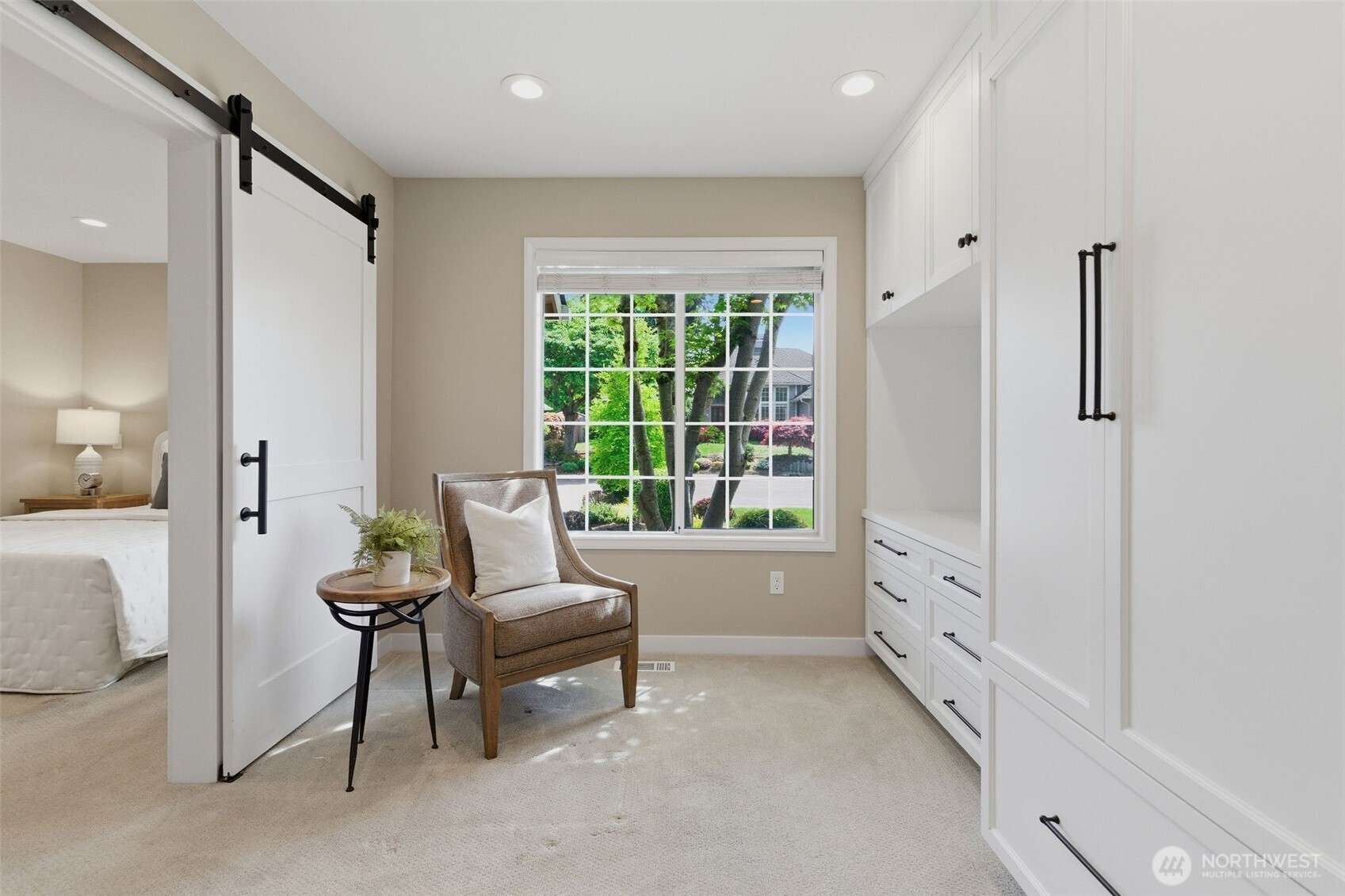 Elegant, light-filled living space with high ceilings and bay windows.