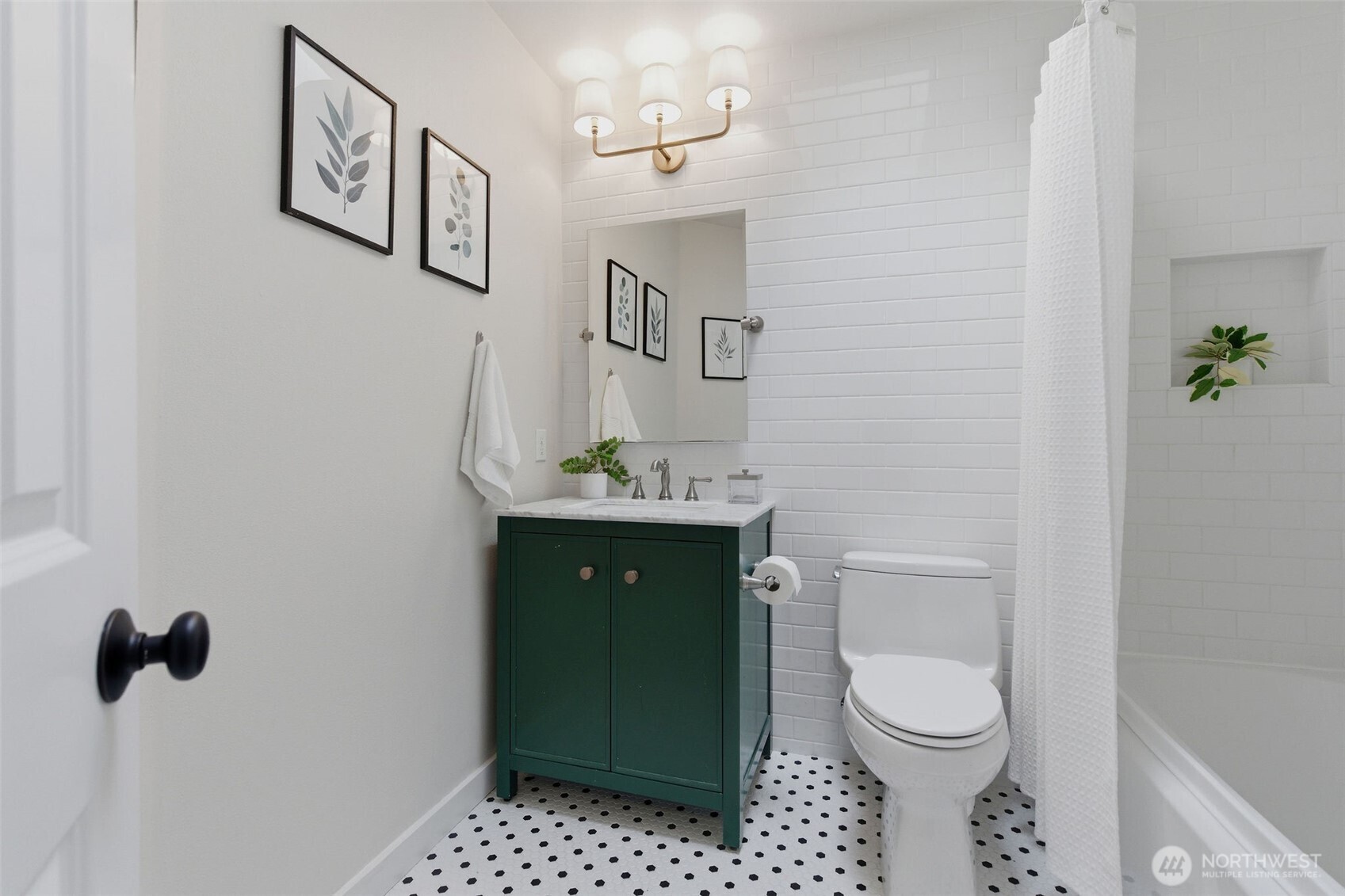 Upstairs hall bathroom with skylight and bathtub.