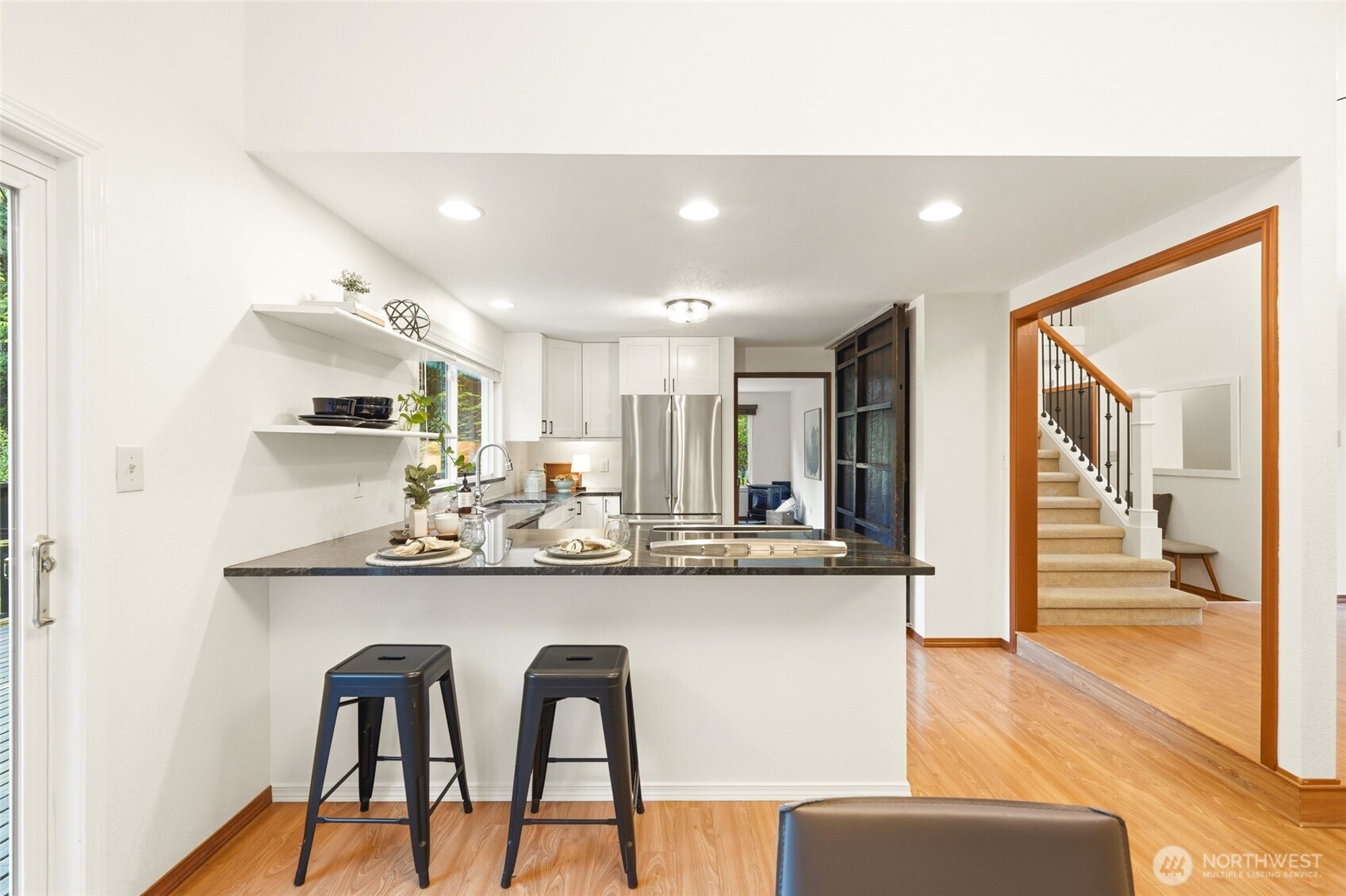 The spacious kitchen features bar seating and a pantry.