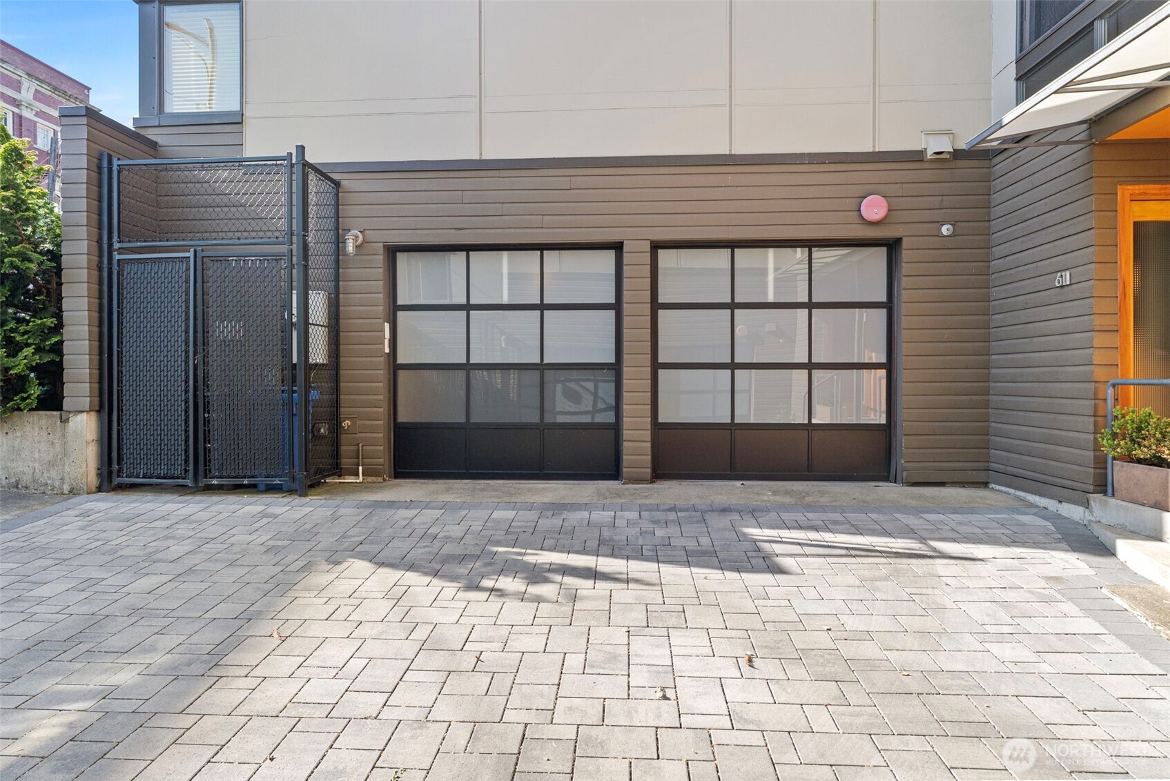 Two car garage and storage cage for garbage cans