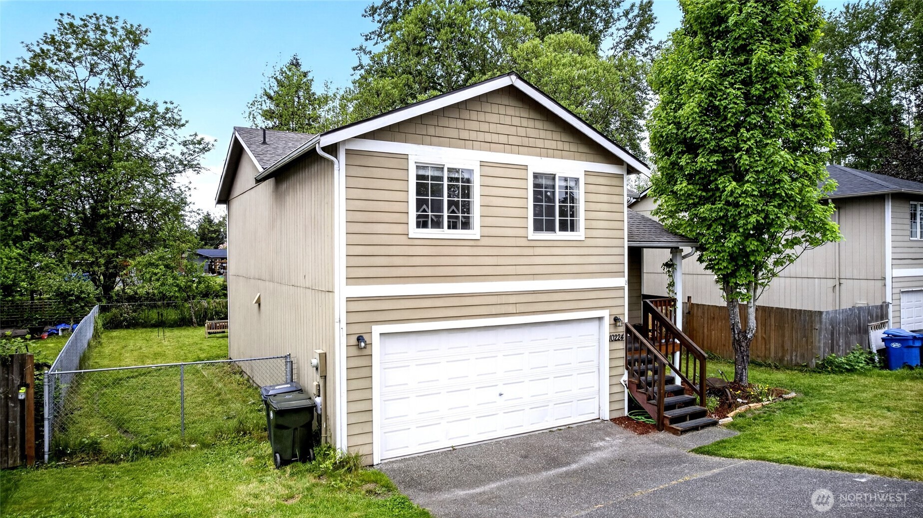 side view of home fully fenced with room to park cars trailers or boats in if needed