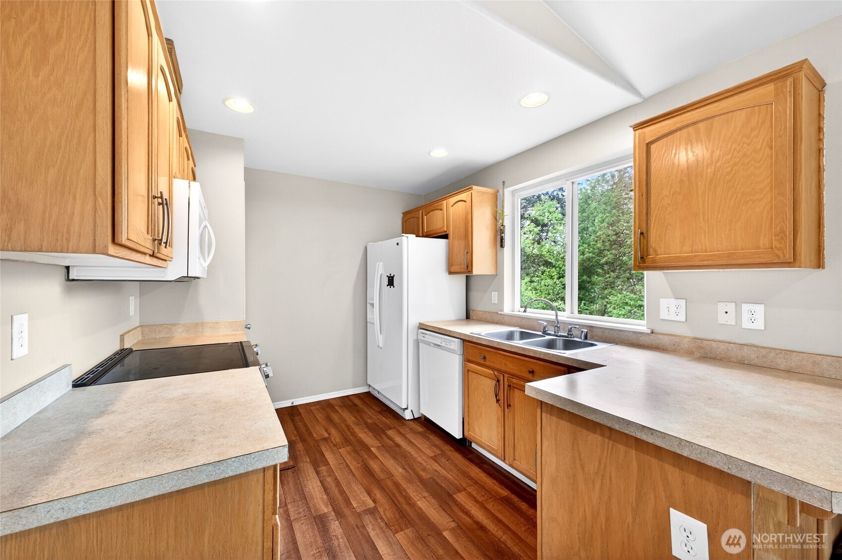 Updated kitchen with lots of counter top space and cabinets with recessed lighting