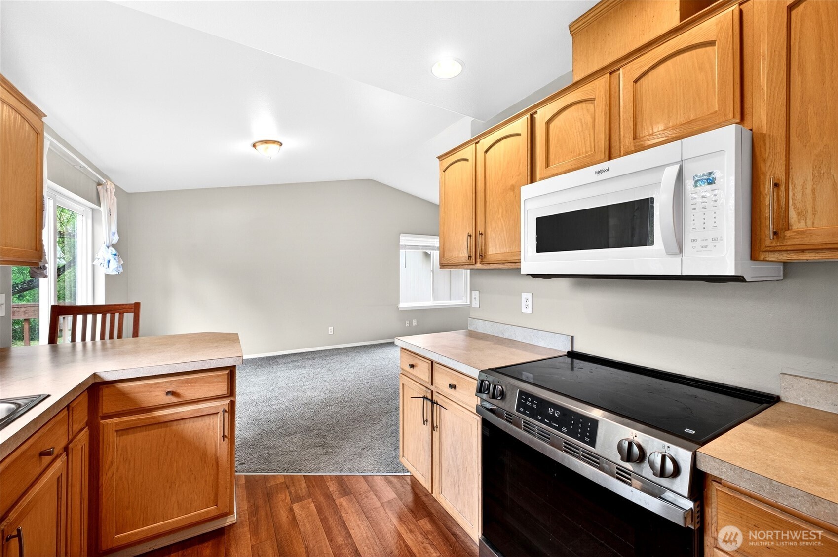 Kitchen view withh newer appliances and lvp flooring