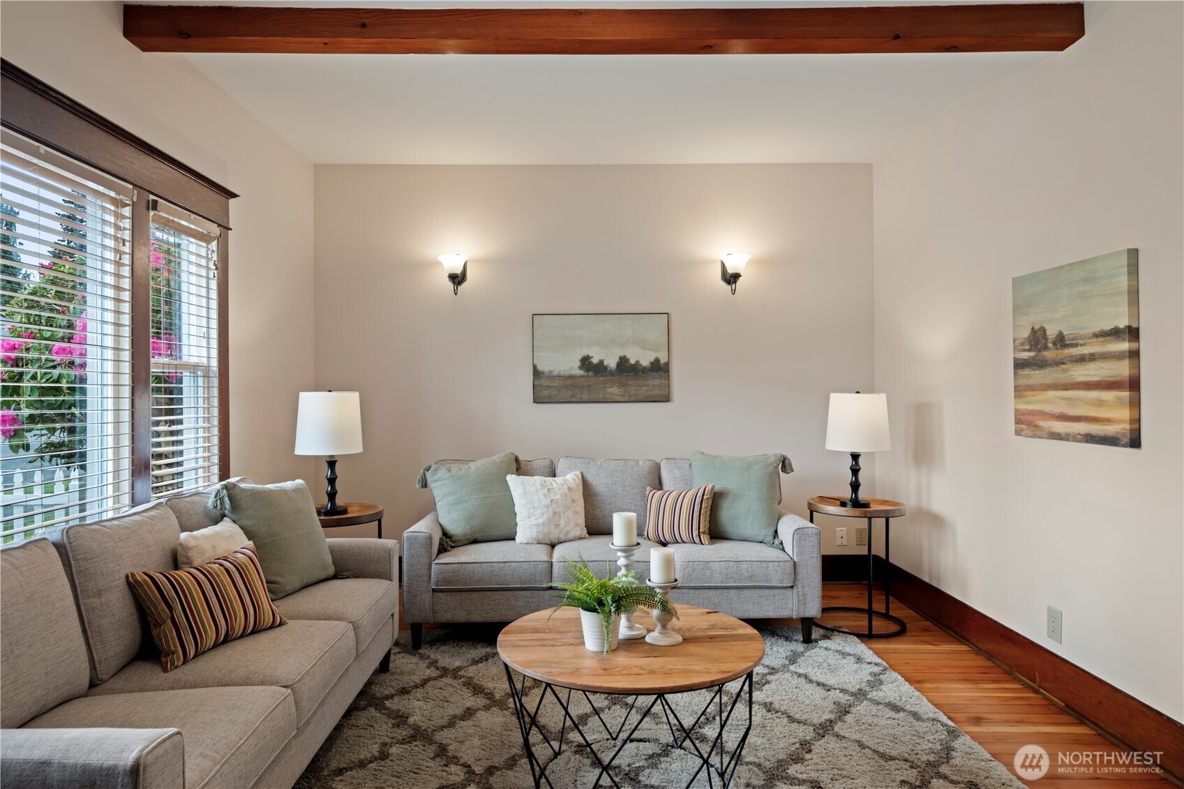 Large windows let afternoon sunlight into the living room