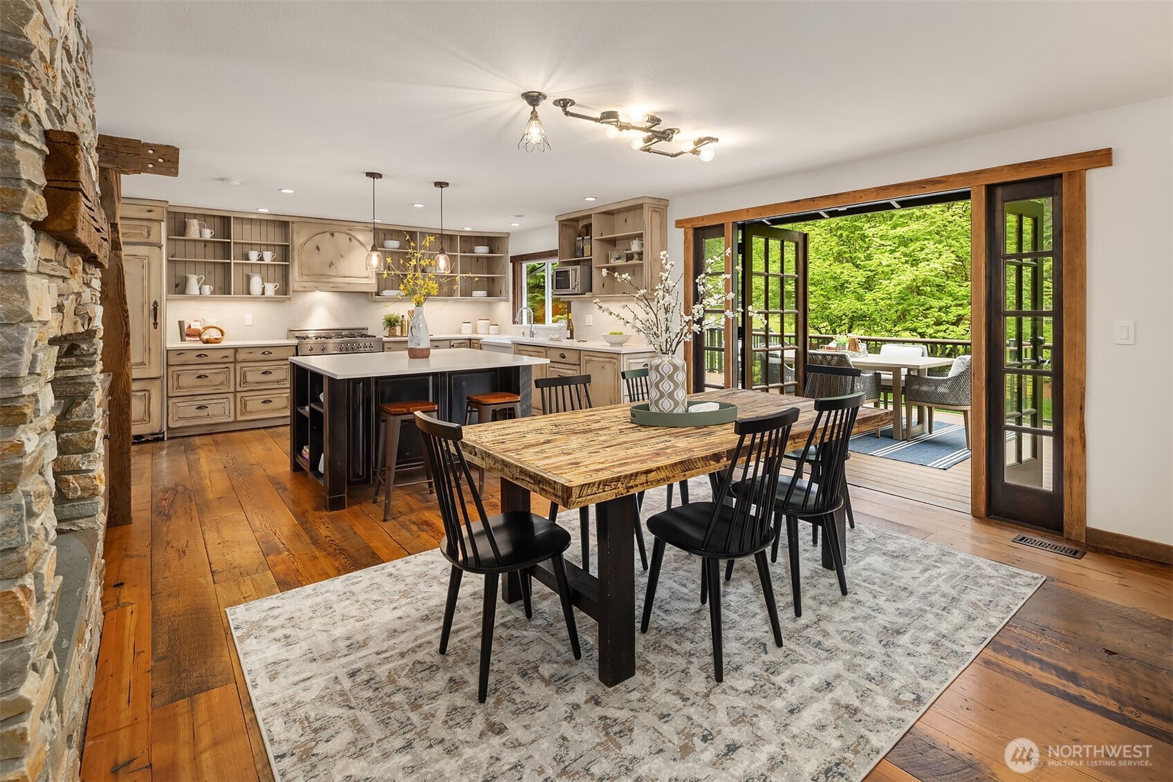 Rustic stone fireplace anchors the kitchen and living room
