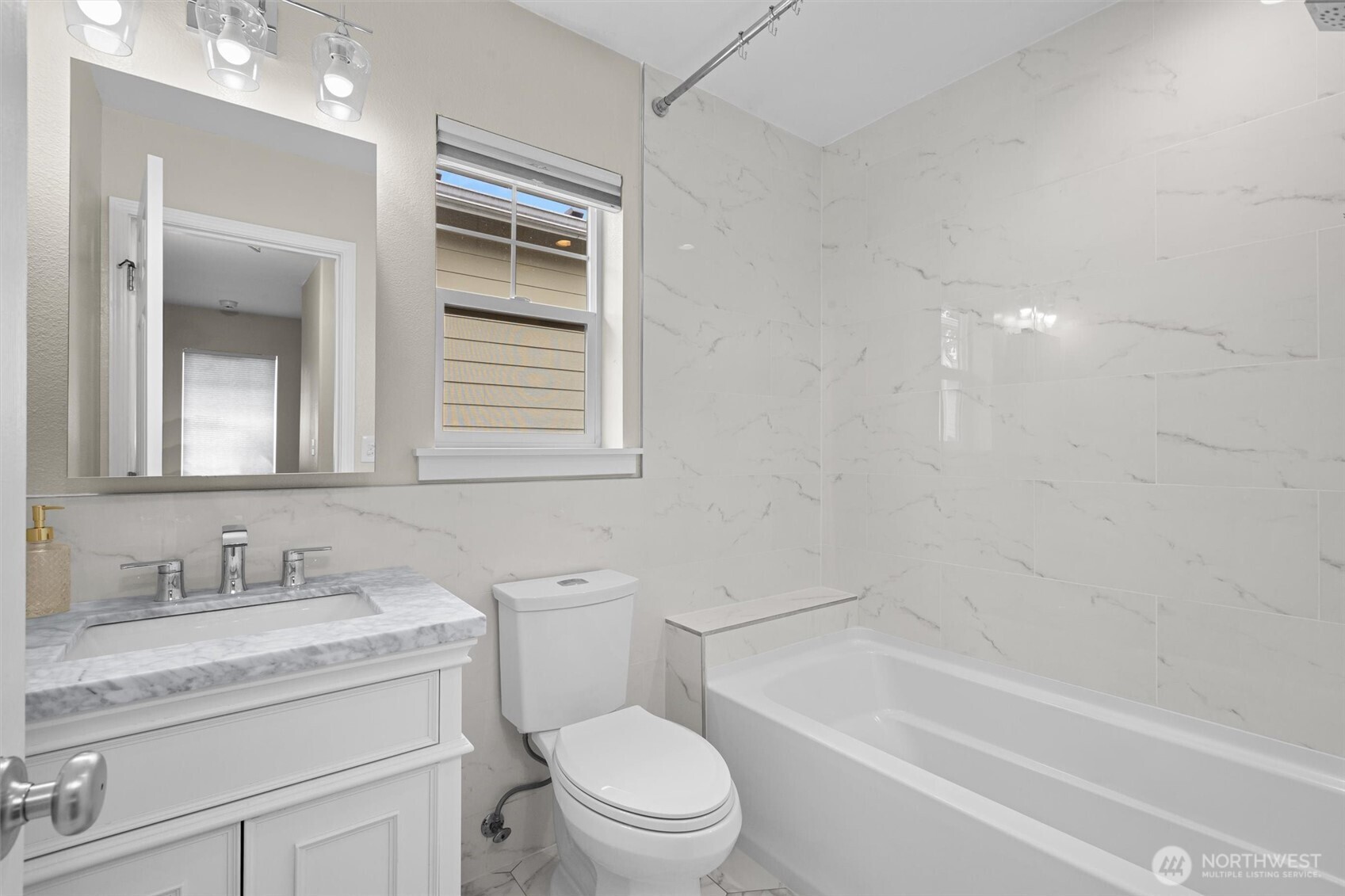 The remodeled full bath in the hallway supports the two bedrooms.