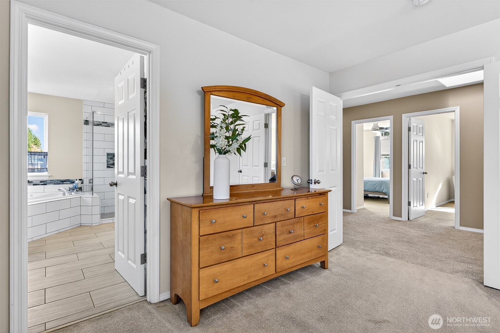 Primary BR, Bathroom & french doors that open to upper hallway and 3 more bedrooms.