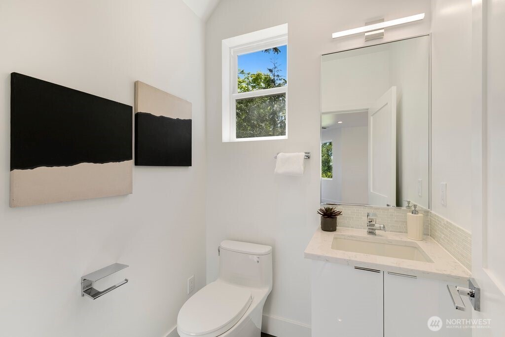 Sleek high-end stainless steel appliances, custom cabinetry, and built-in shelving offer both sophistication and practicality