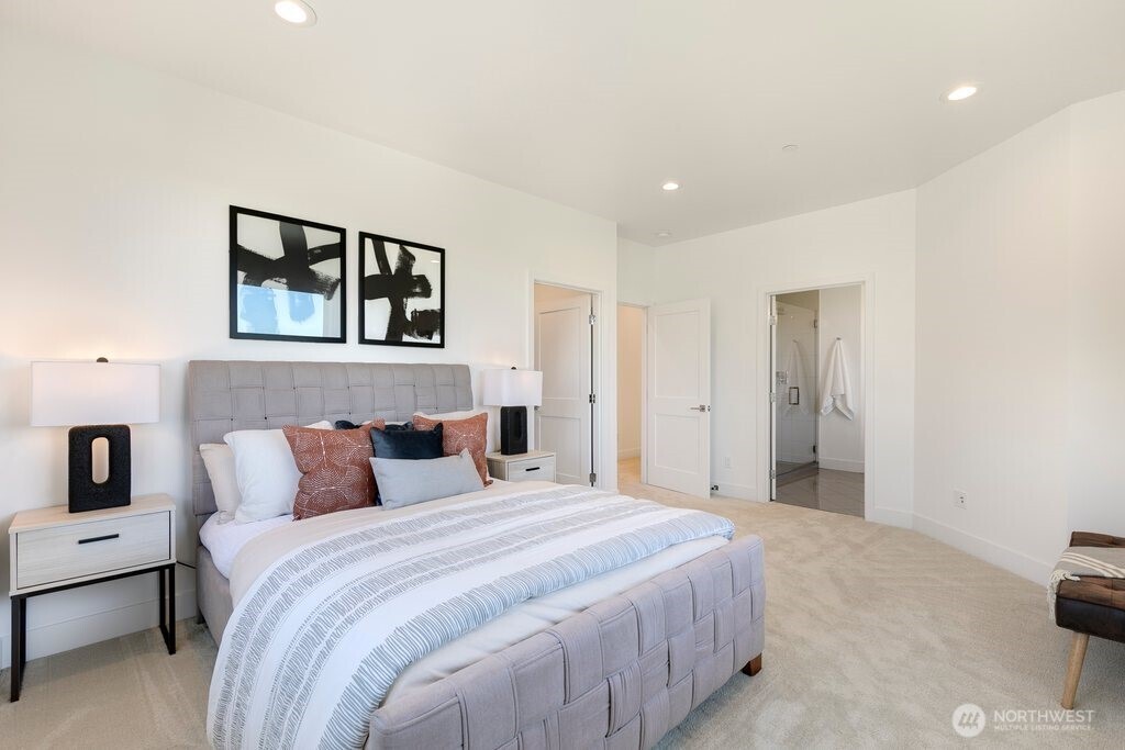 The spa-inspired en-suite bath offers a luxurious retreat with a spacious double vanity, abundant storage, a relaxing soaking tub, and an oversized shower
