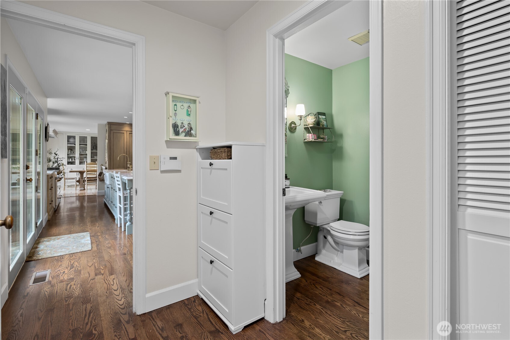 Lots of designed storage on both sides of the custom island with marble countertop.