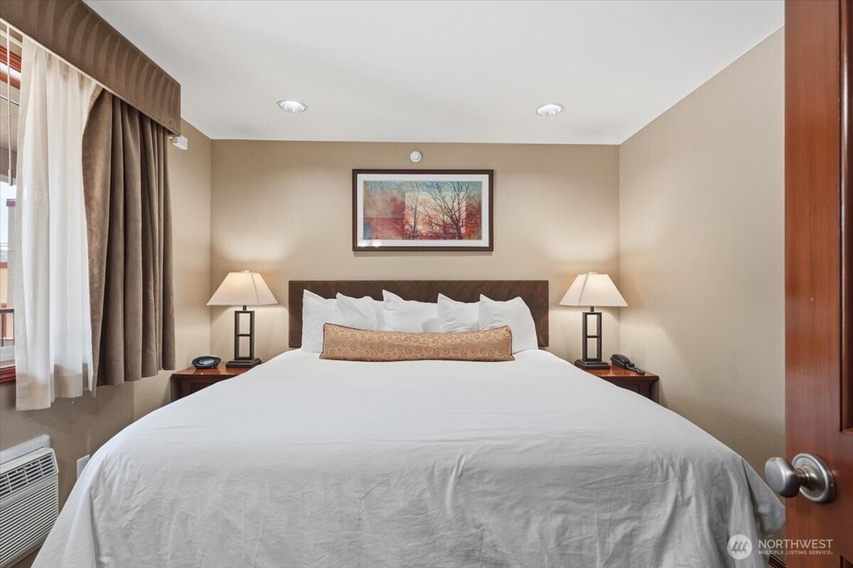 Spacious primary suite featuring a large king-size bed designed for comfort and relaxation.