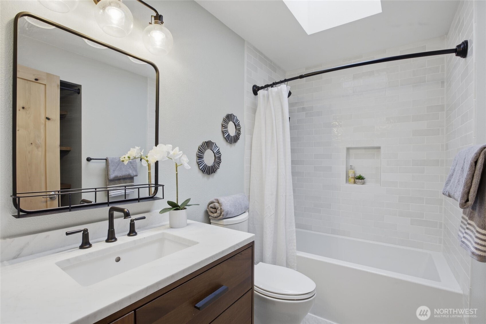 Elegant Woodinville living with hardwood flooring, vaulted ceilings, and timeless designer finishes