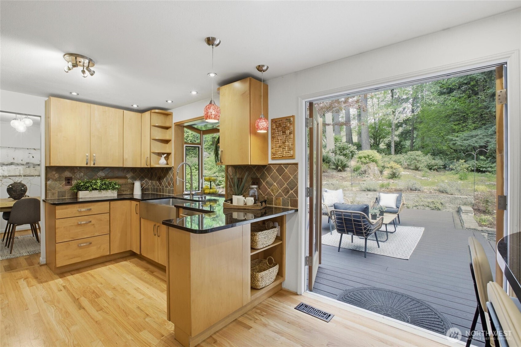 Serene Woodinville property offering indoor outdoor living surrounded by mature landscaping and greenbelt privacy