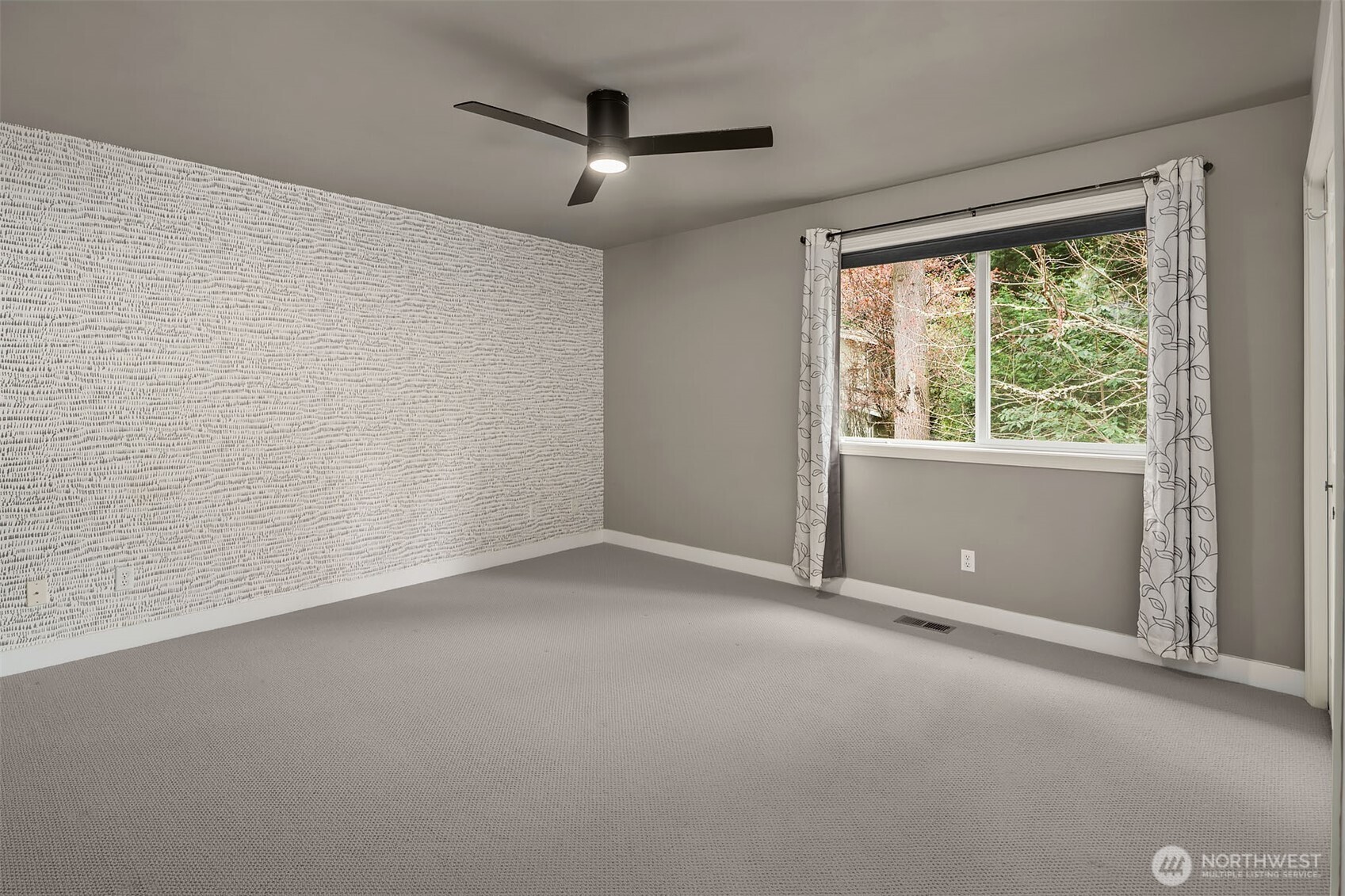 Primary bedroom with sunny window seat and custom built-ins.