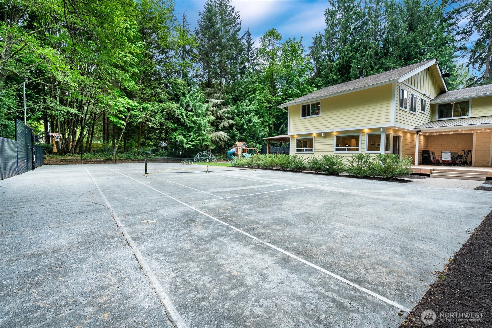Pickleball and basketball court AND still TONS of grassy yard!
