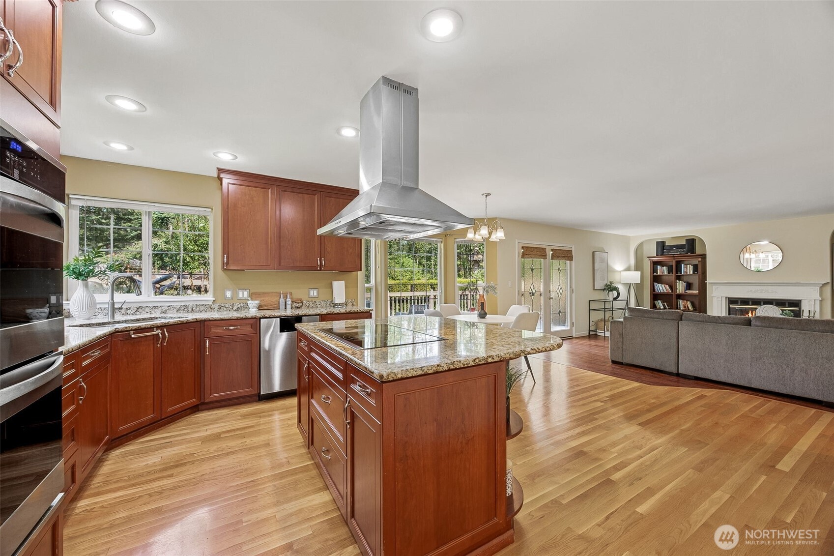 Large center island holds your cook station with overhead ventilation hood sure to impress the chef in the house.