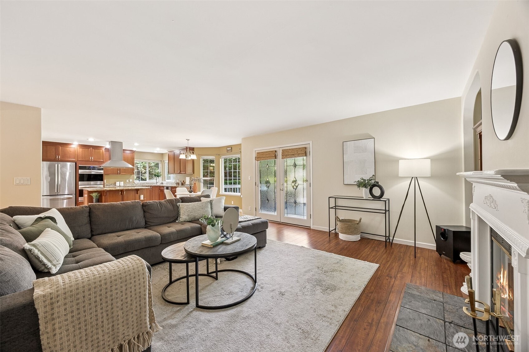 Handsome dark, rich wood flooring in the family room complements the kitchen cabinetry beautifully and is pleasing to the eye. French doors step out to the deck maximizing your entertainment space.