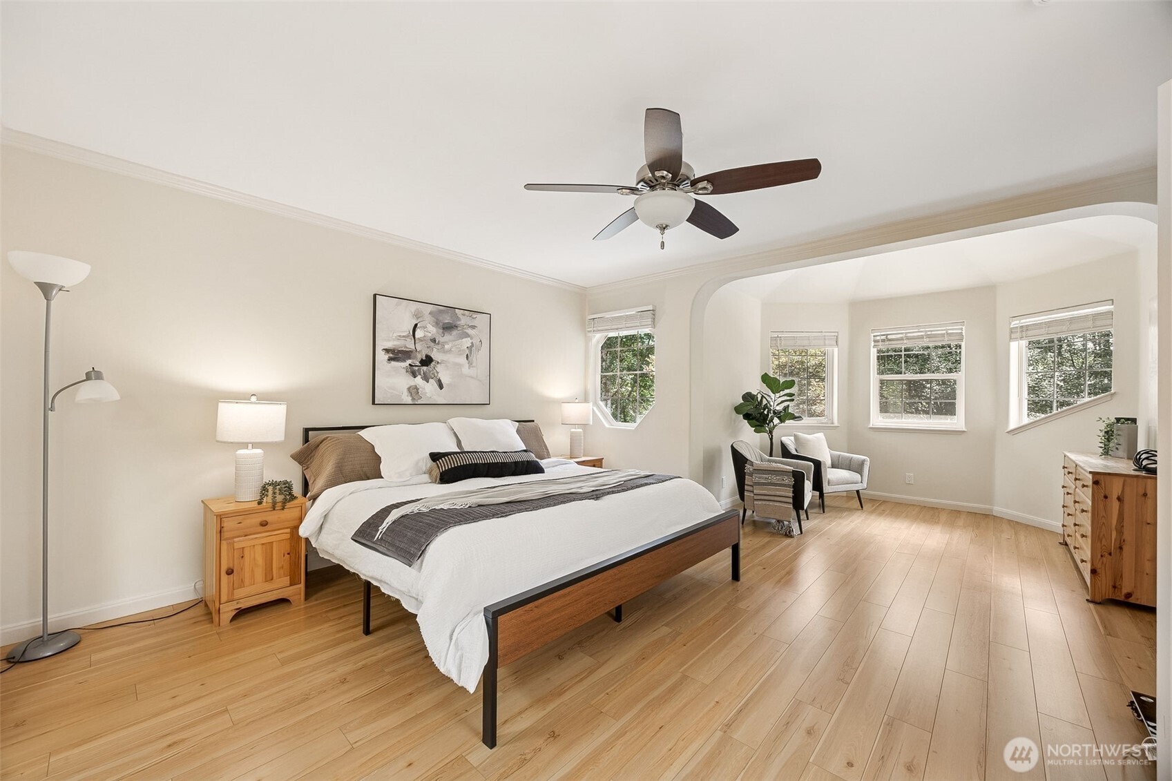 Presenting the primary suite, your own personal retreat that is light and airy and inviting, boasting of wide planked flooring and a soft neutral pallet. Enjoy the sitting area perfect for reading or relaxing.